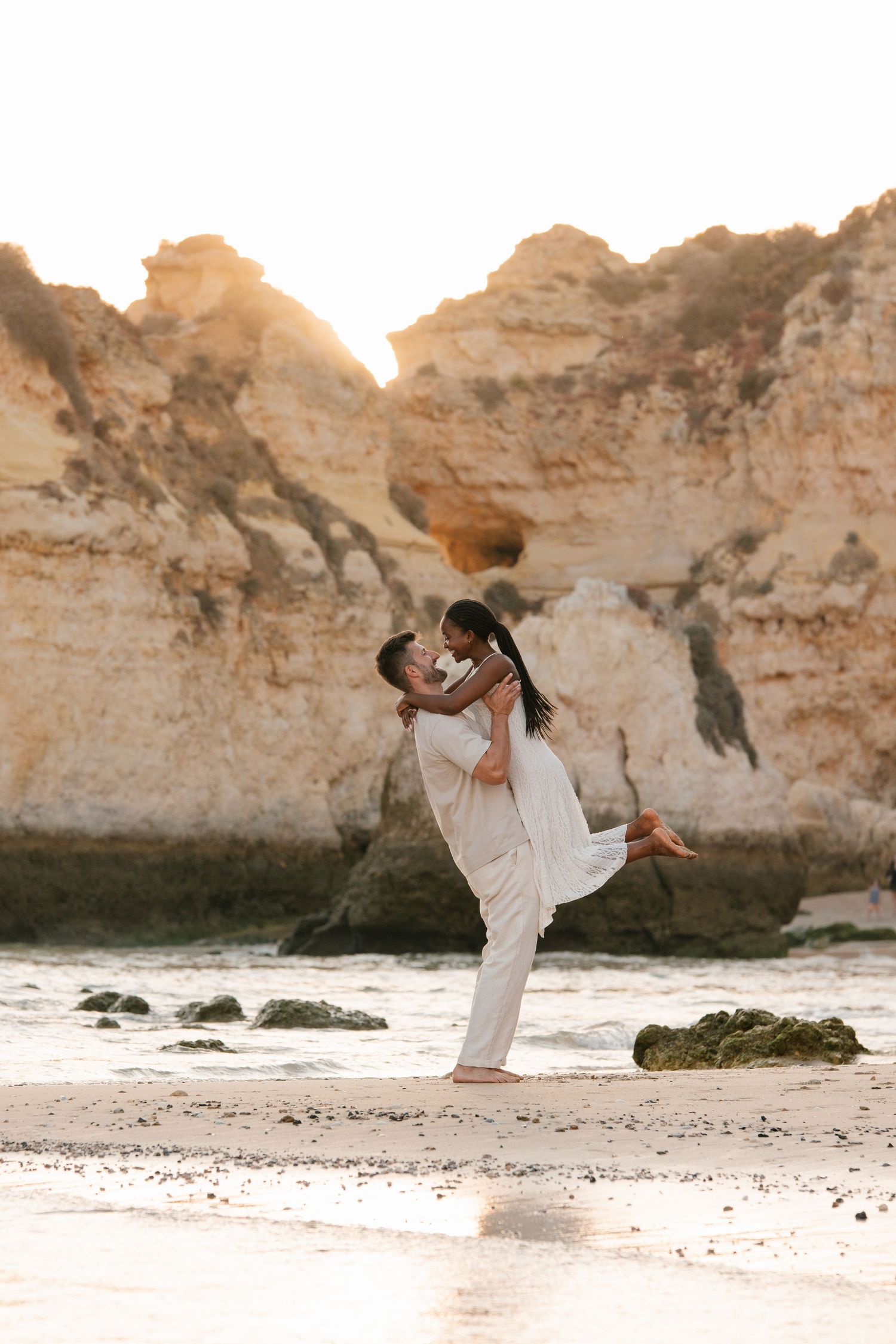 couple most beautiful engagement moment in portugal coast. Man lifting is wife.