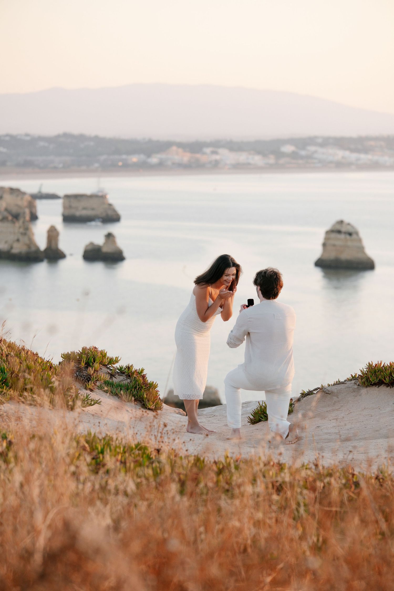 sunrise proposal on the cliffs of Praia da Camilo with iconic Lagos rock formations in the background