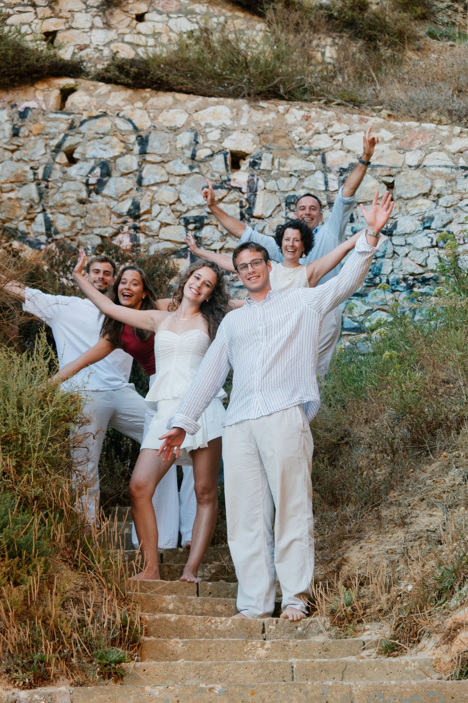family photo on natural stairs with rock formations at Três Irmãos