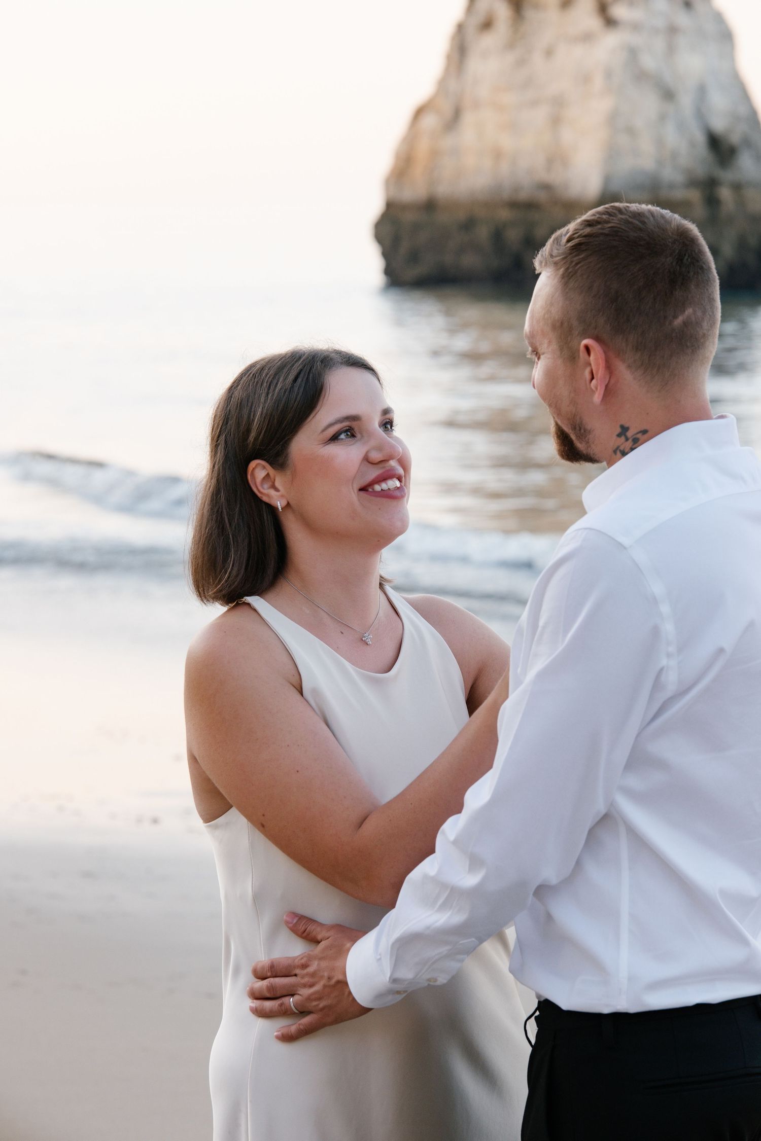 couple embracing during a romantic beach photoshoot in Portugal