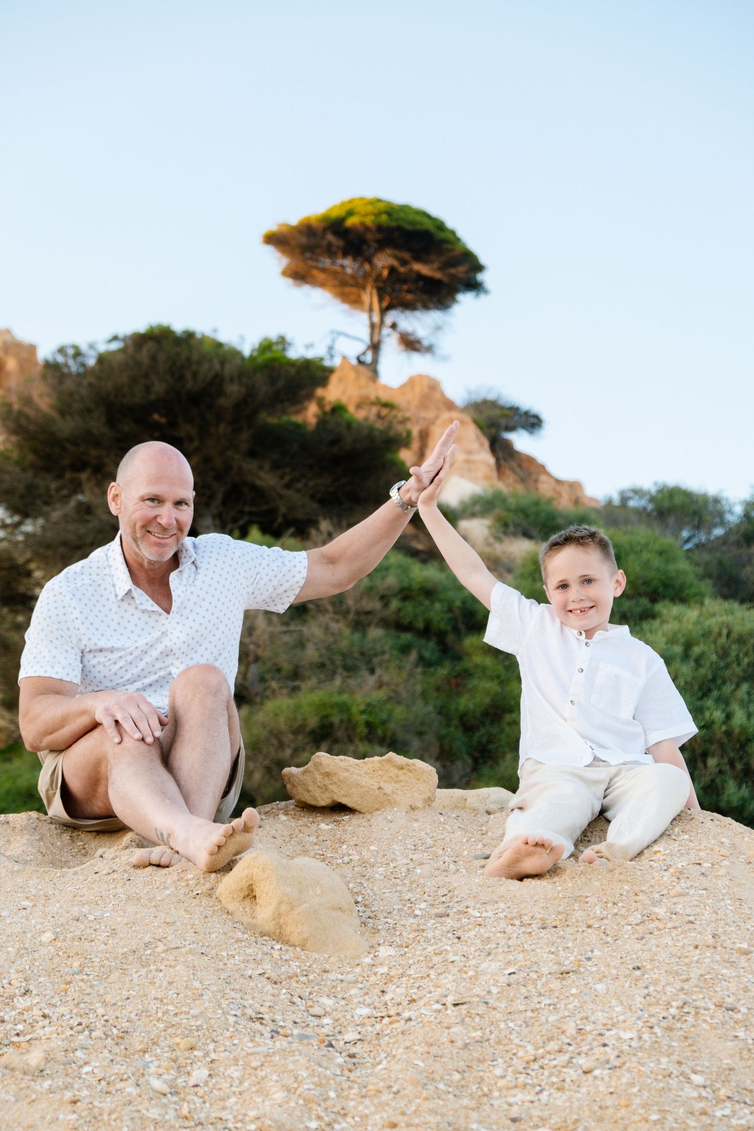 high five with father and son on a stunning beach in the algarve
