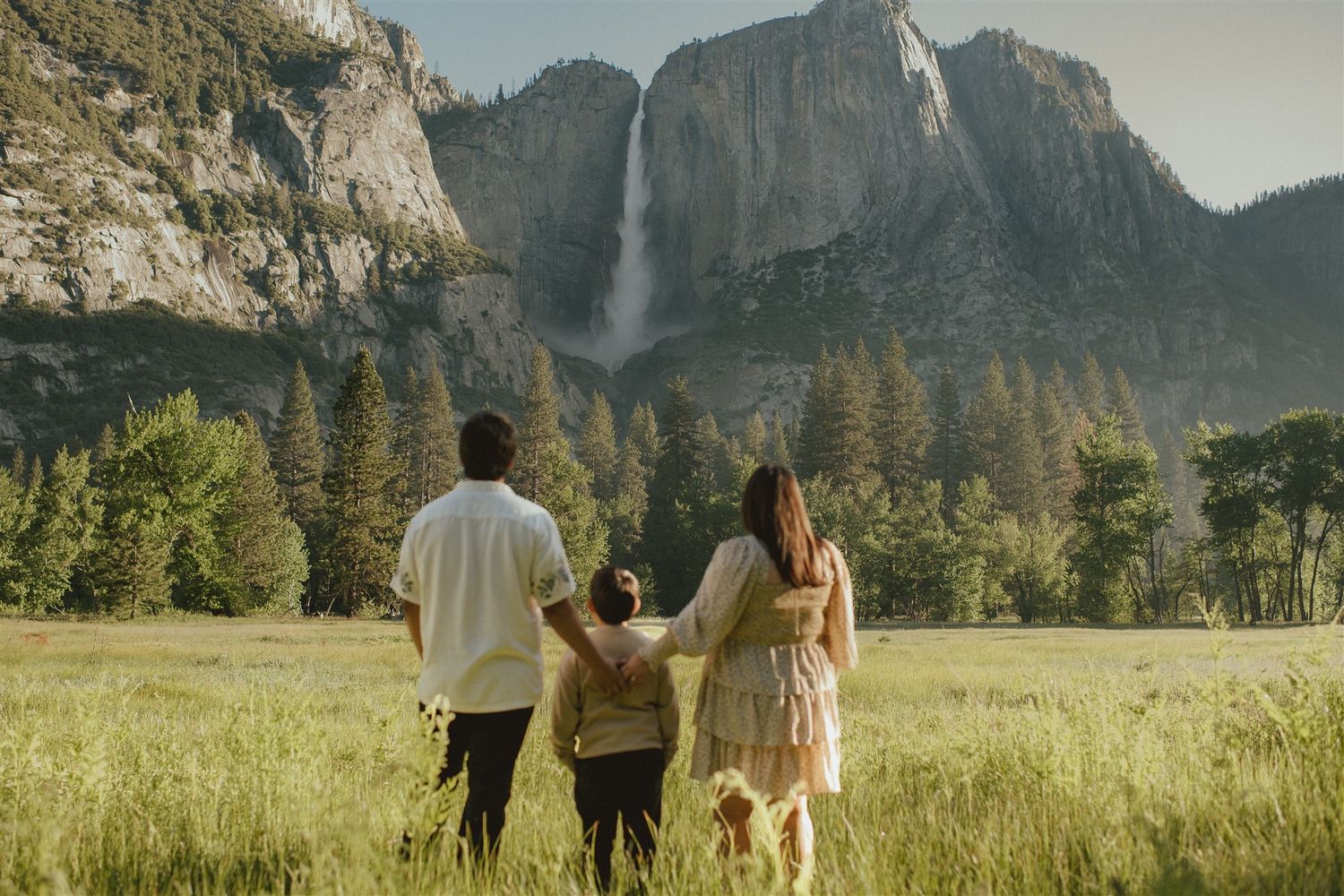 FAMILY PHOTO SESSION WATCHING A WATERFALL AT YOSEMITE NATIONAL PARK.
