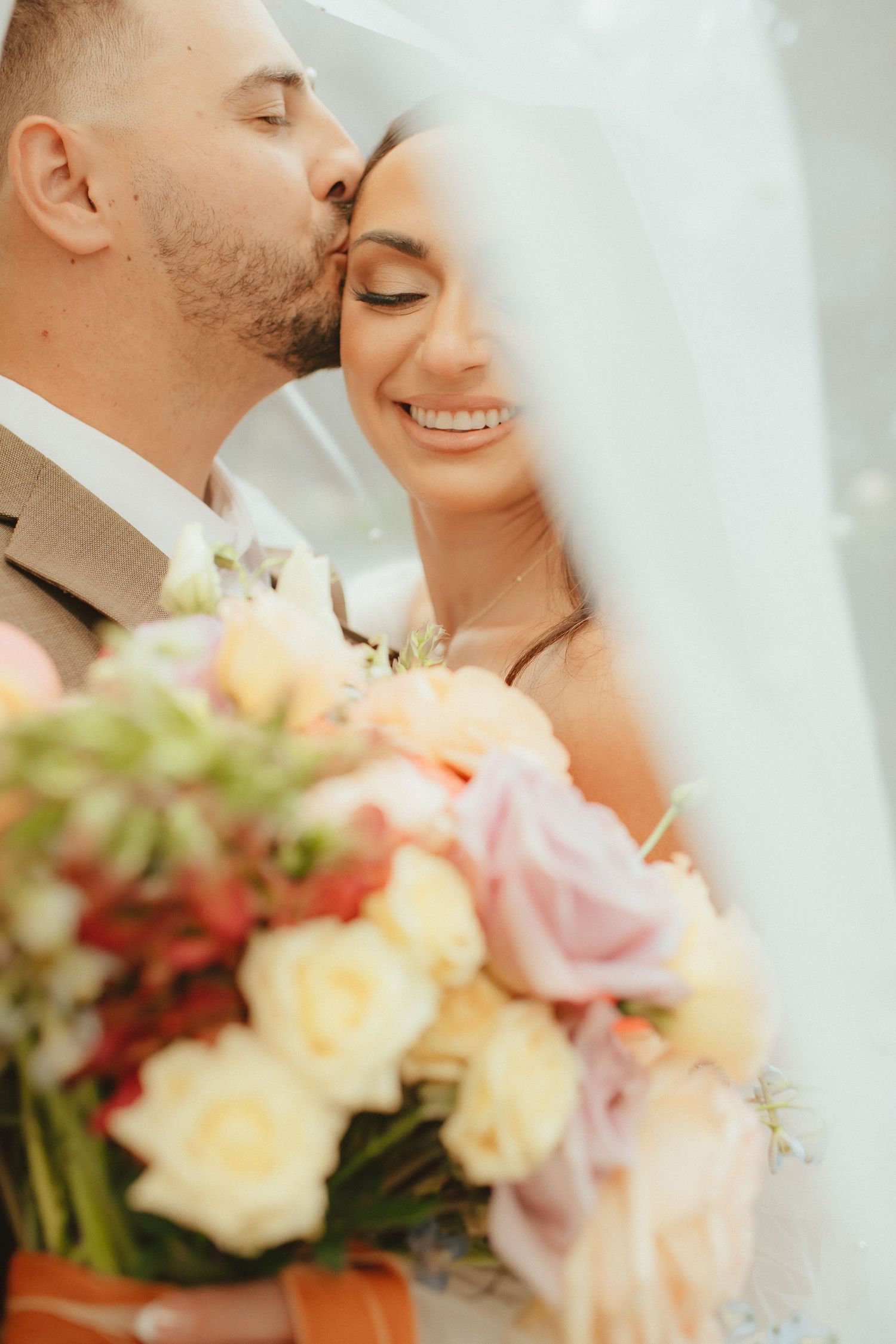 wedding couple portraits kissing with bouquet location hanford, california