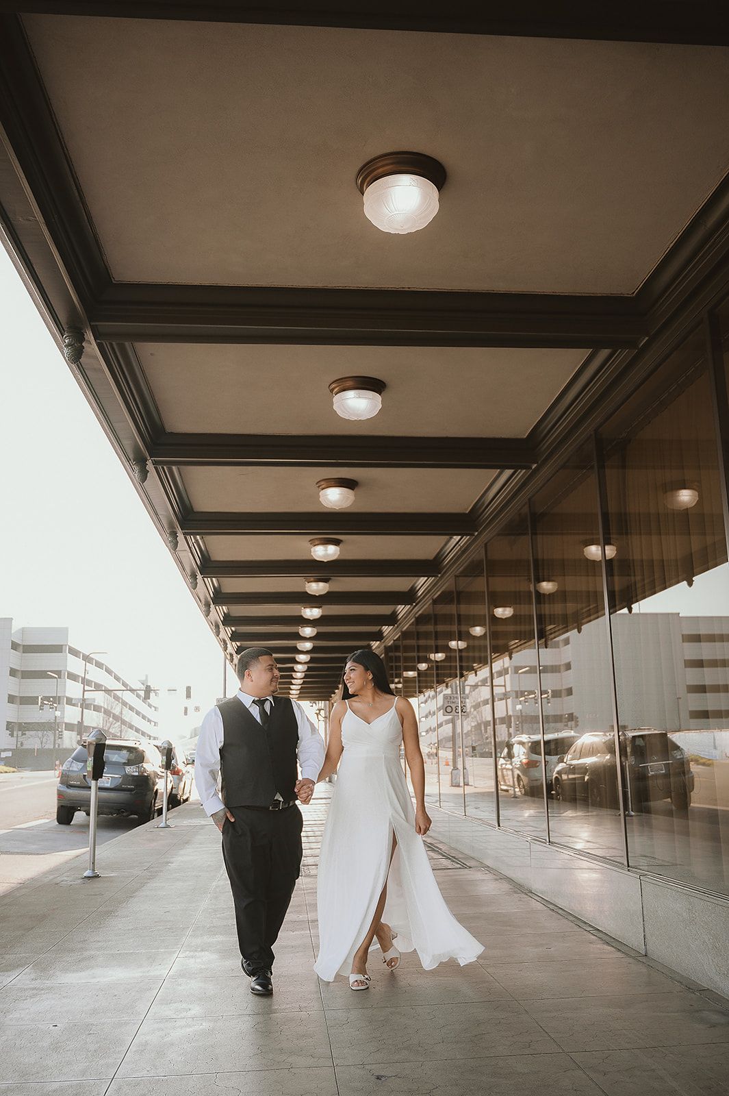 city engagement couple with white elegance dress in Downton Fresno california