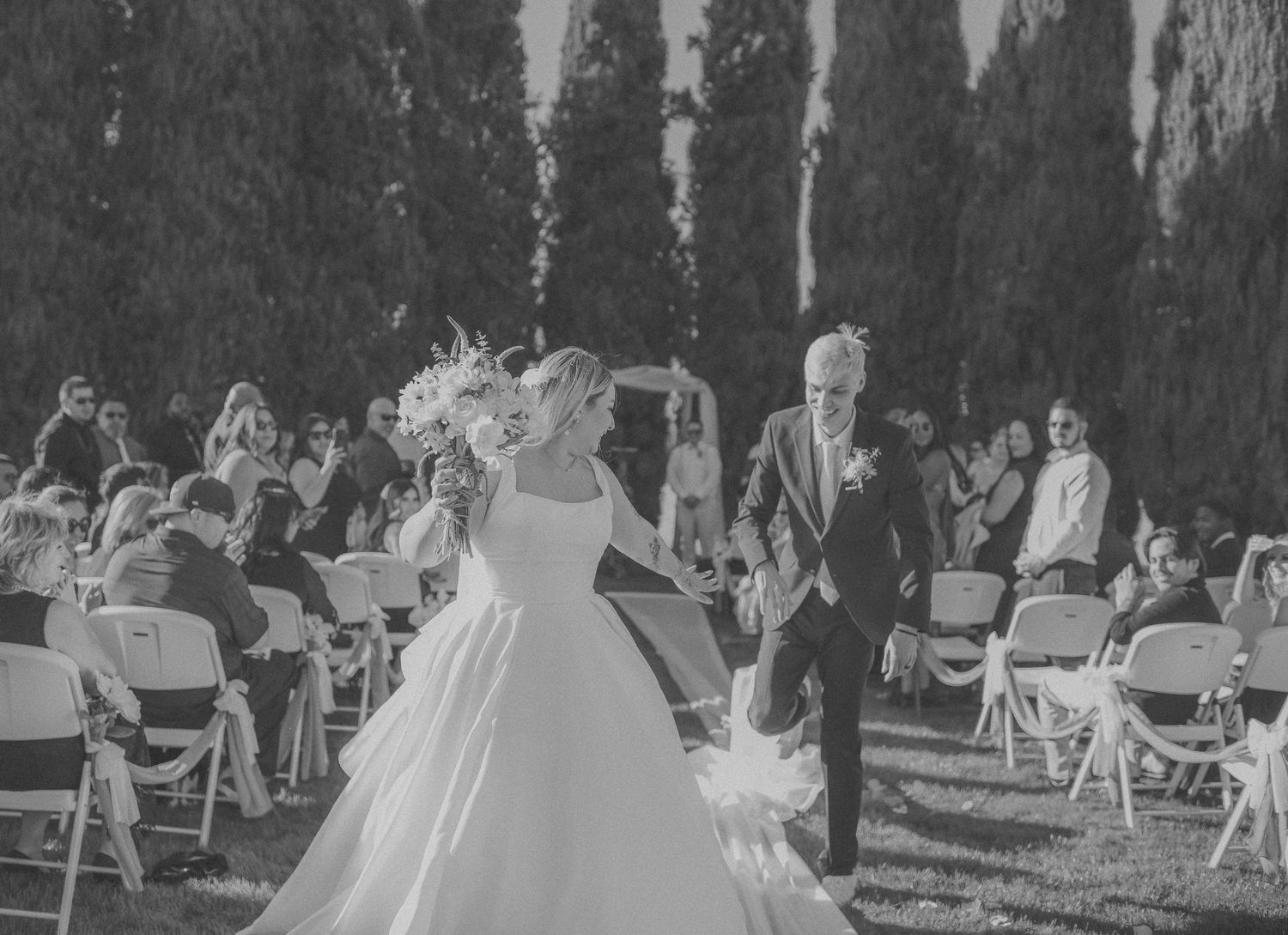 black and white wedding couple walking down the aisle together. in Fresno california