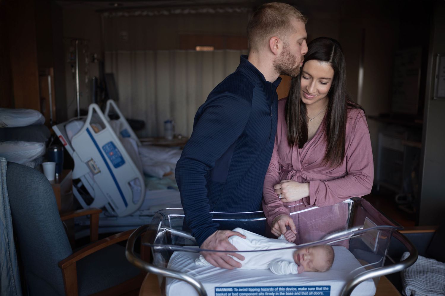 Fresh 48 hospital session with newborn boy and parents, tender kiss moment after delivery in Columbus, Ohio.