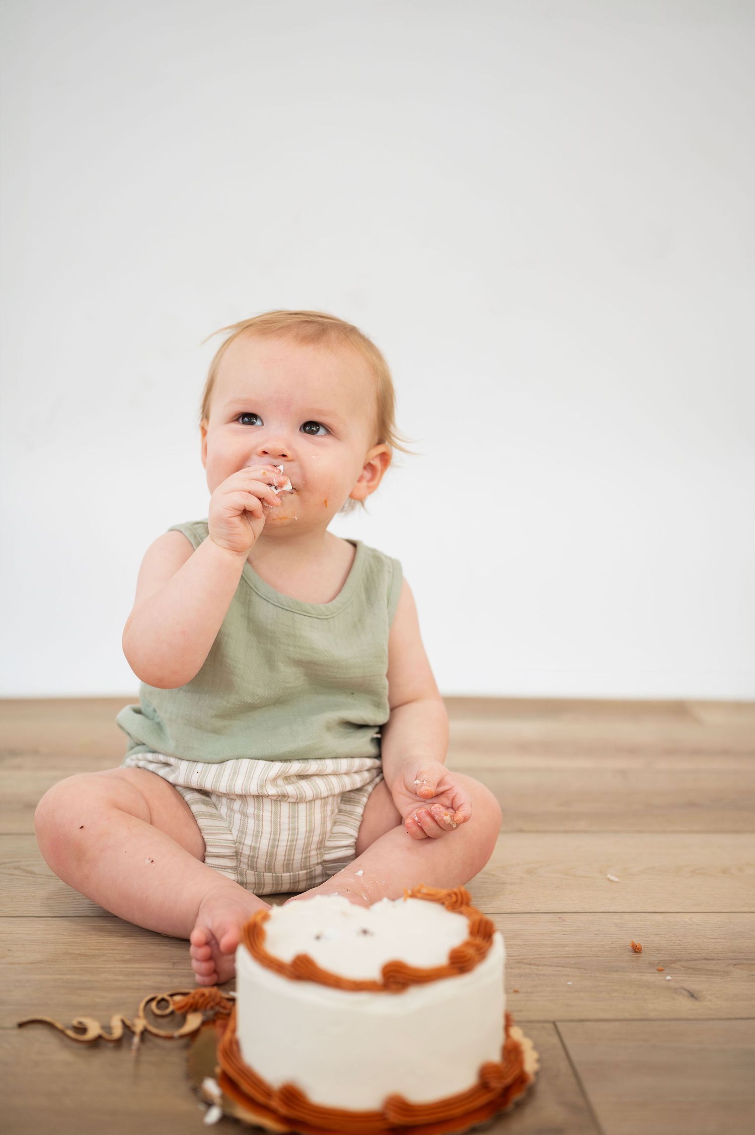 Studio milestone session with baby tasting cake—Westerville cake smash photographer