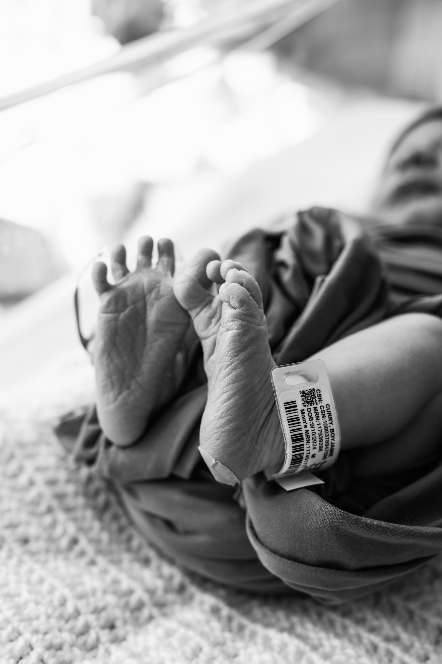 Tiny wrinkled toes, freshly born and perfectly still. A timeless Fresh 48 black-and-white by Boundless Joy Photography.