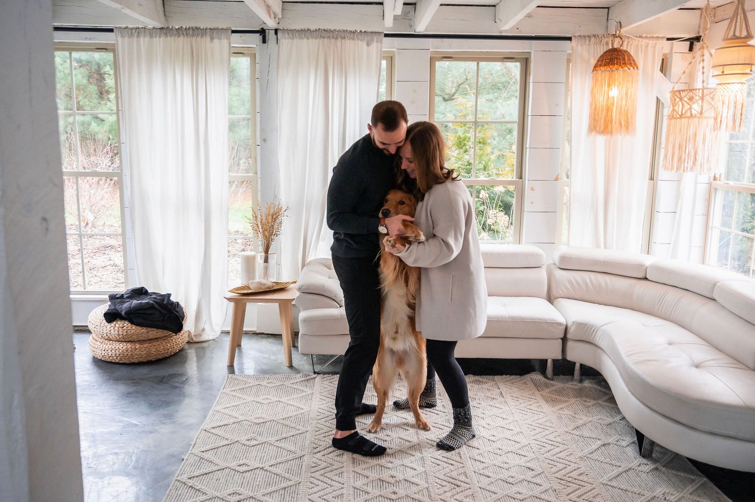 Couple dancing in their sunroom with their dog—cozy lifestyle session in Columbus, Ohio