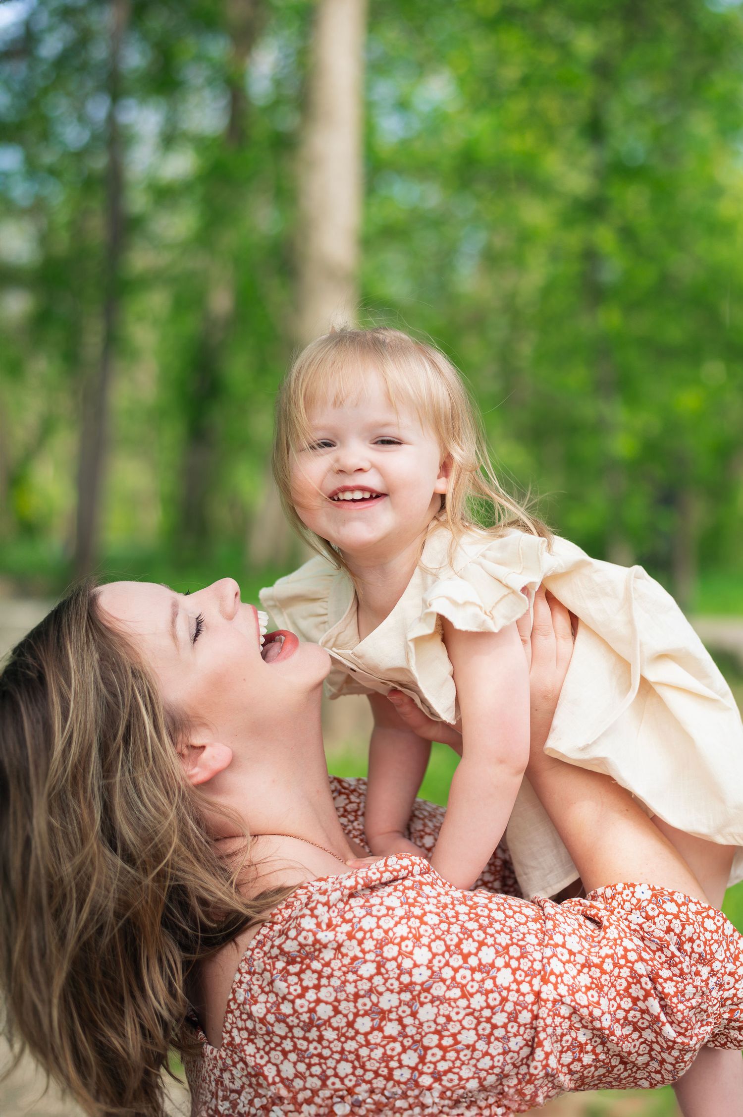 Mom lifting toddler daughter during spring family session—Westerville family photographer