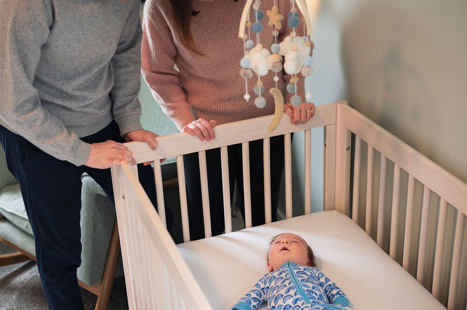 Love looking down into the crib and seeing those bright eyes looking back. Newborn lifestyle sessions in your own nursery.