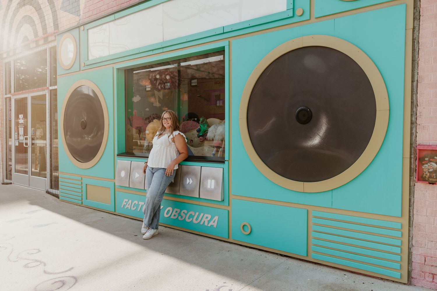 Series of retro-styled diner or laundromat windows with turquoise frames and circular porthole-style designs.