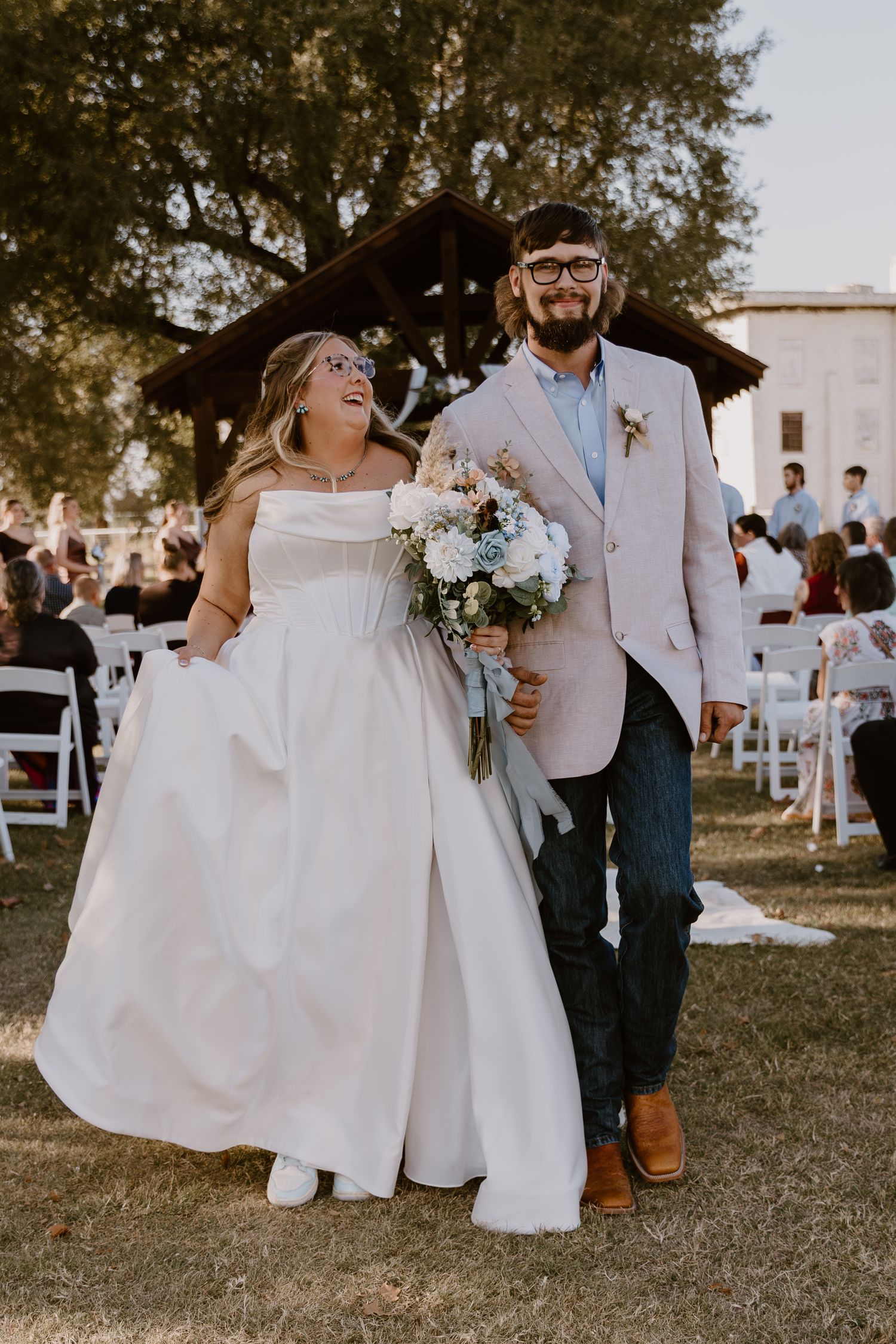 Candid wedding photos showing joyful moments of a couple dancing and embracing at an outdoor reception in white attire.