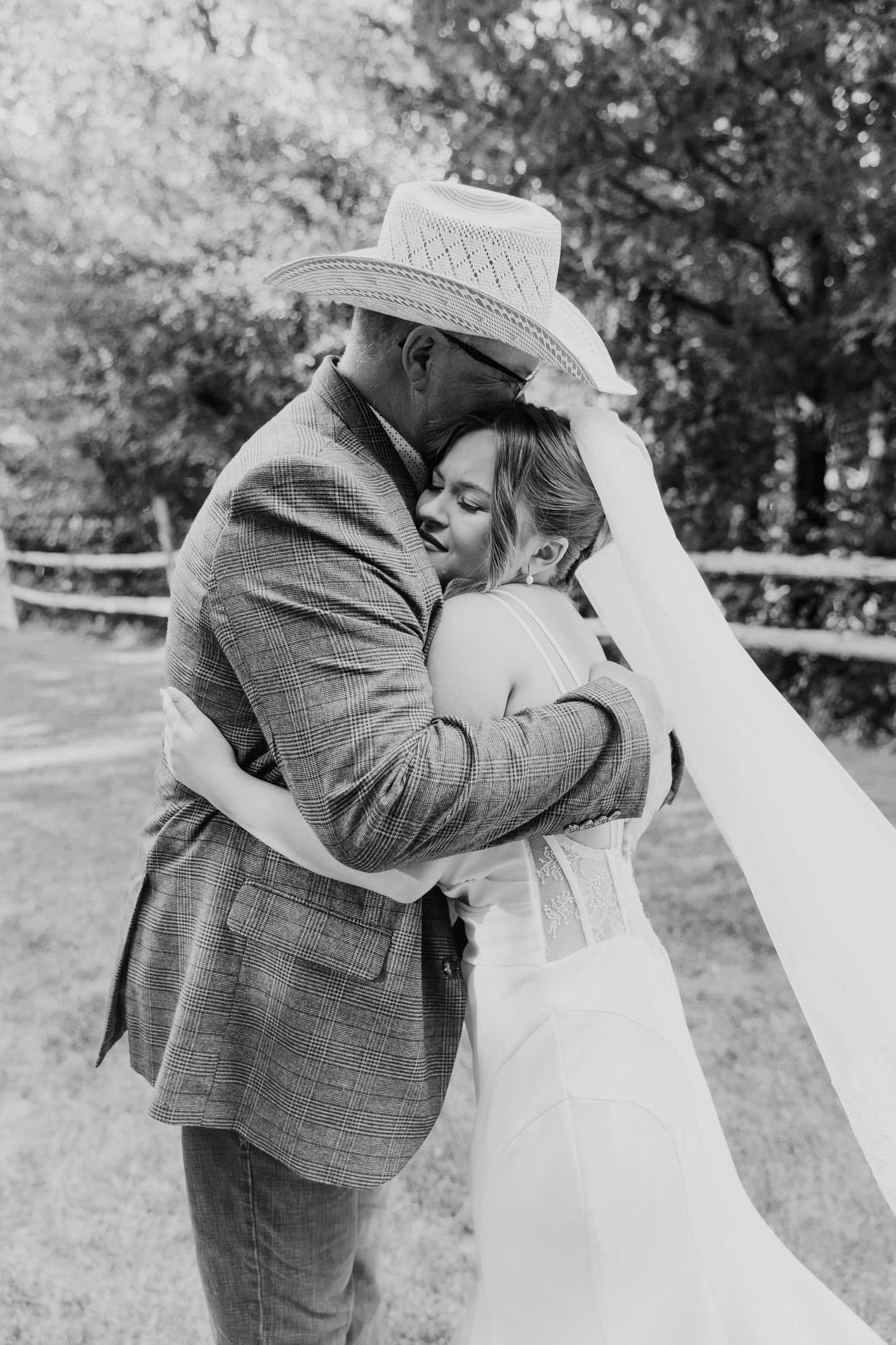 A romantic black and white photo sequence of a couple embracing and kissing outdoors in wedding attire.
