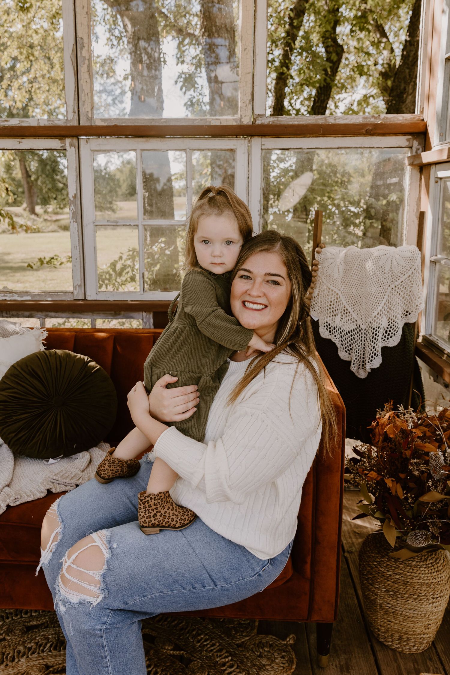 Candid lifestyle photos showing warm moments in a sunlit indoor setting with cozy autumn decor.