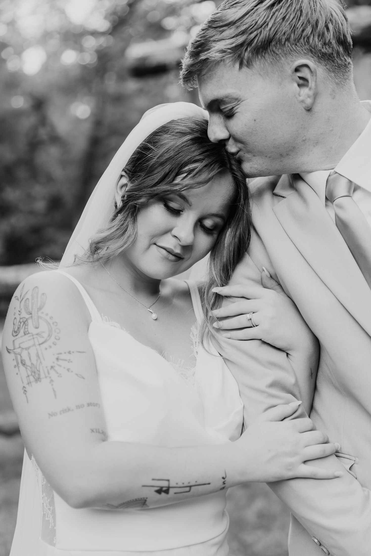 Intimate black and white wedding portraits showing tender moments shared between a couple.