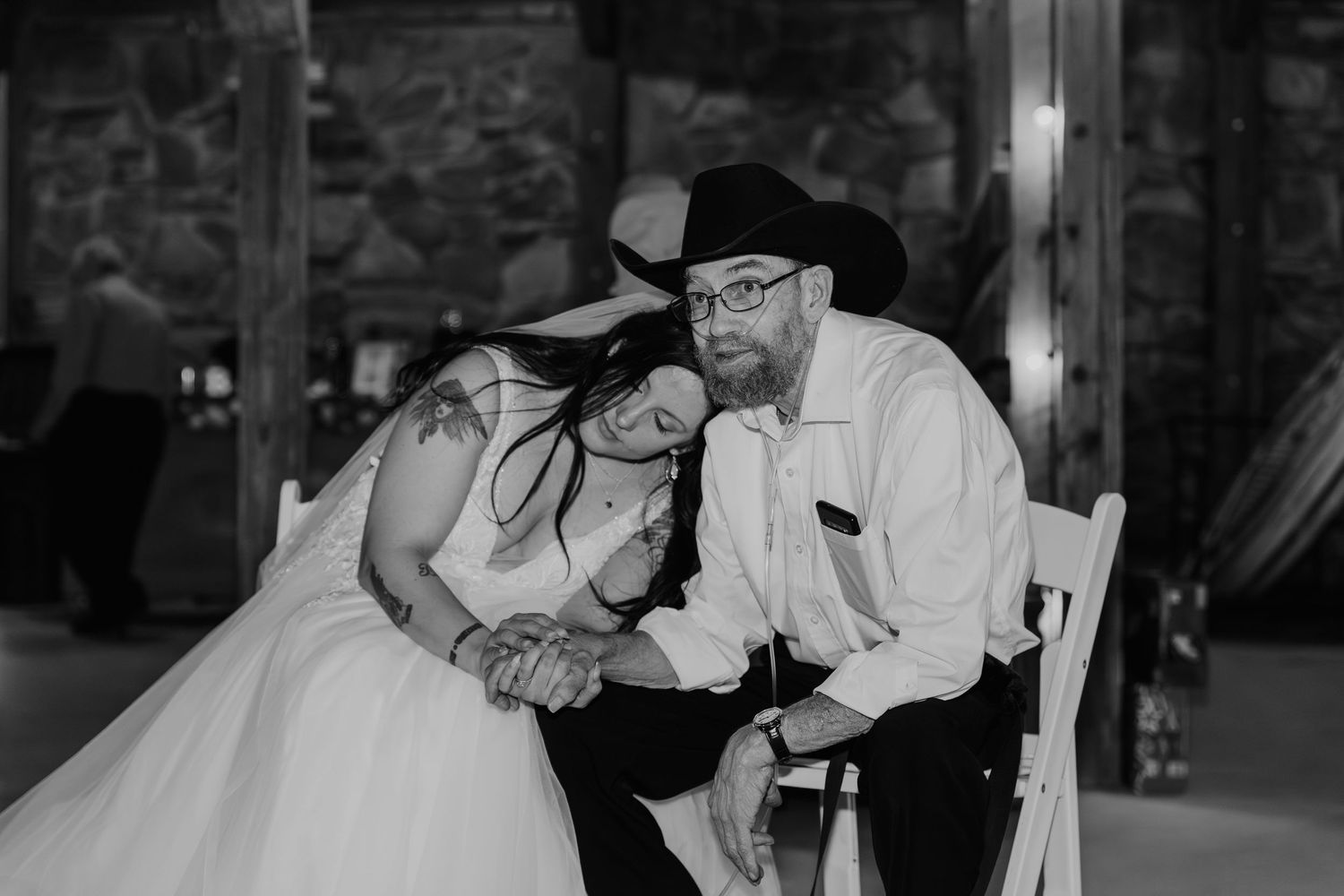 A tender black and white moment between a wedding couple as they share an intimate embrace during their reception.