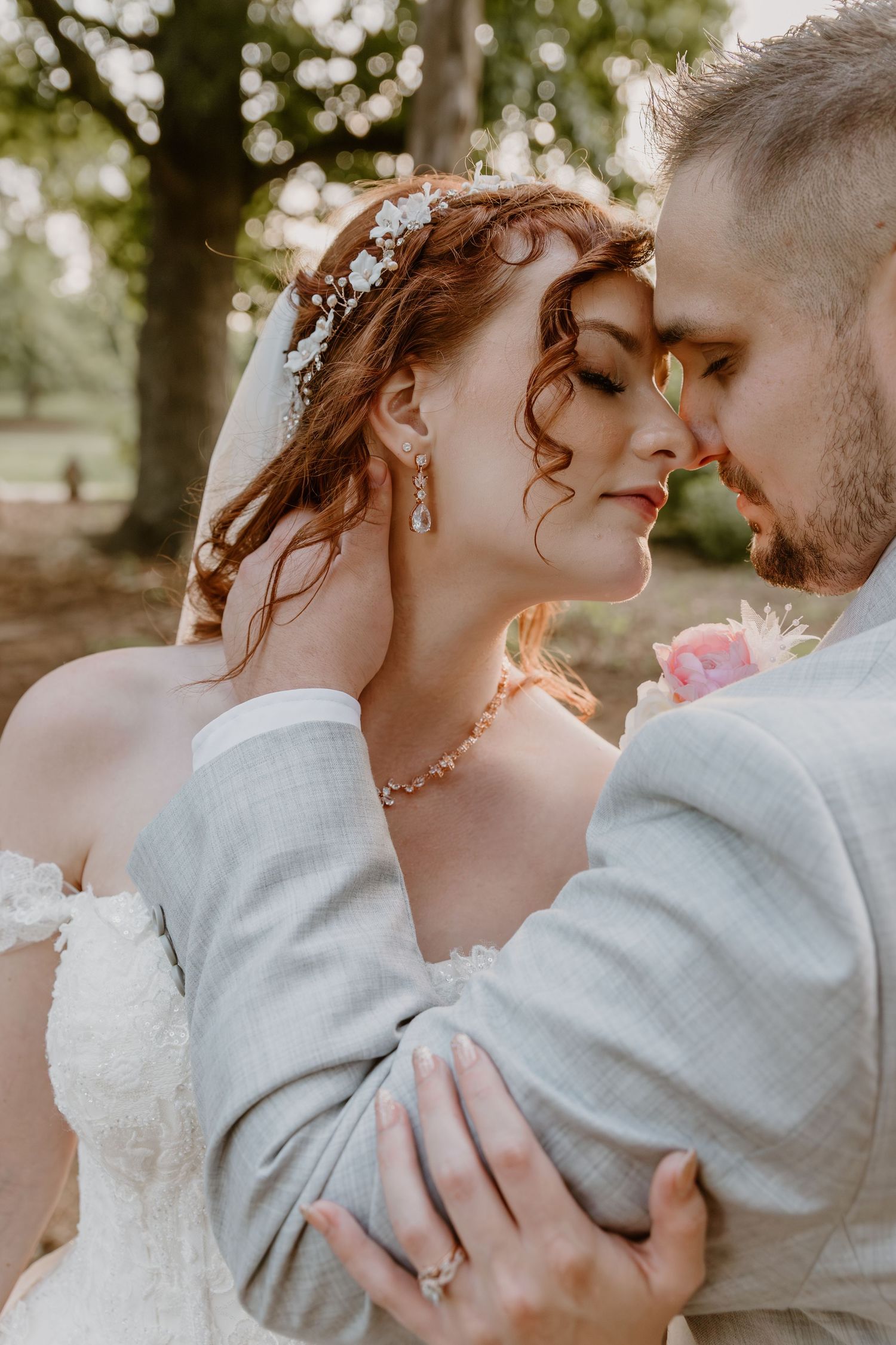 Romantic wedding portraits showing tender moments between couple in outdoor setting with soft lighting.