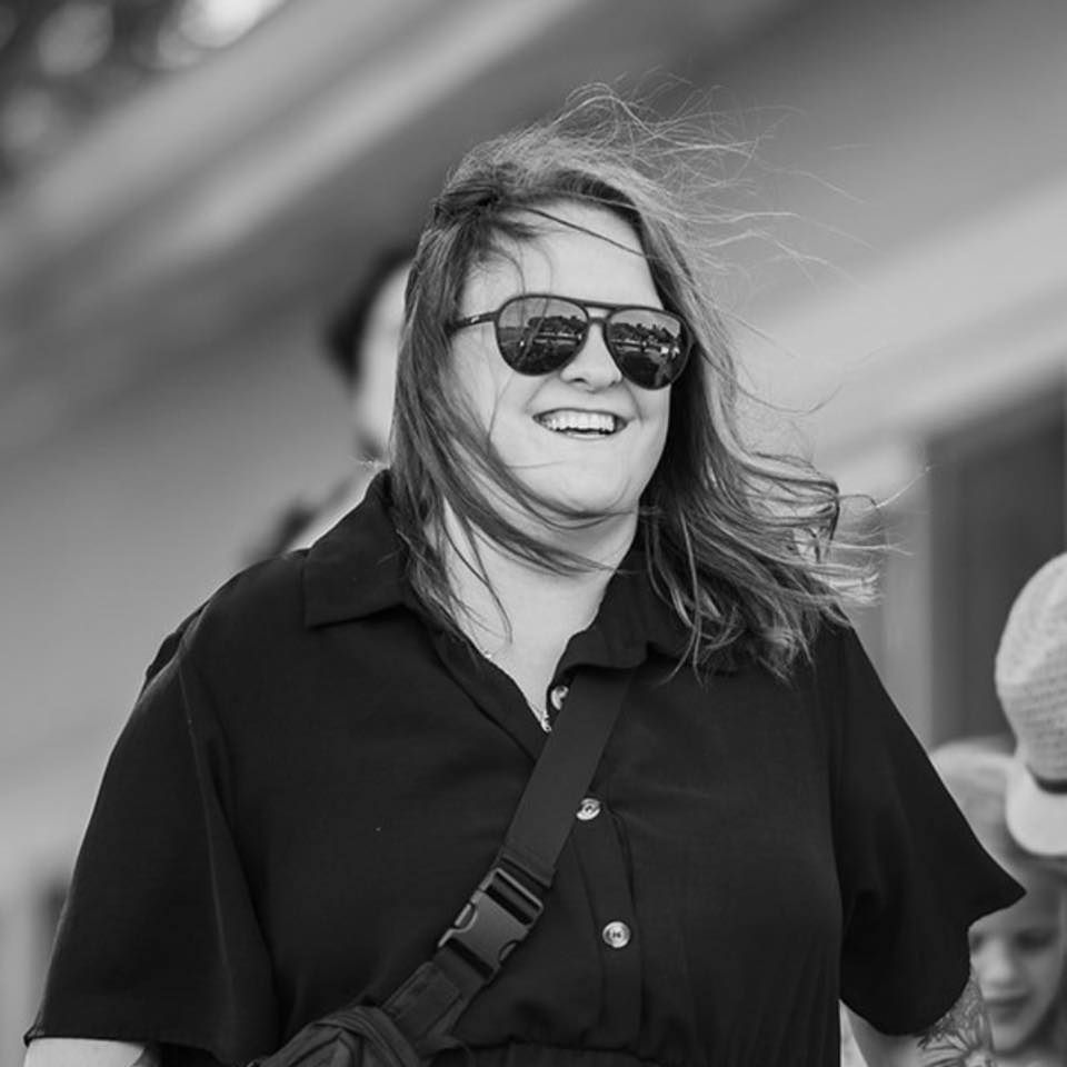 Black and white photo series showing someone smiling and laughing with various joyful expressions.