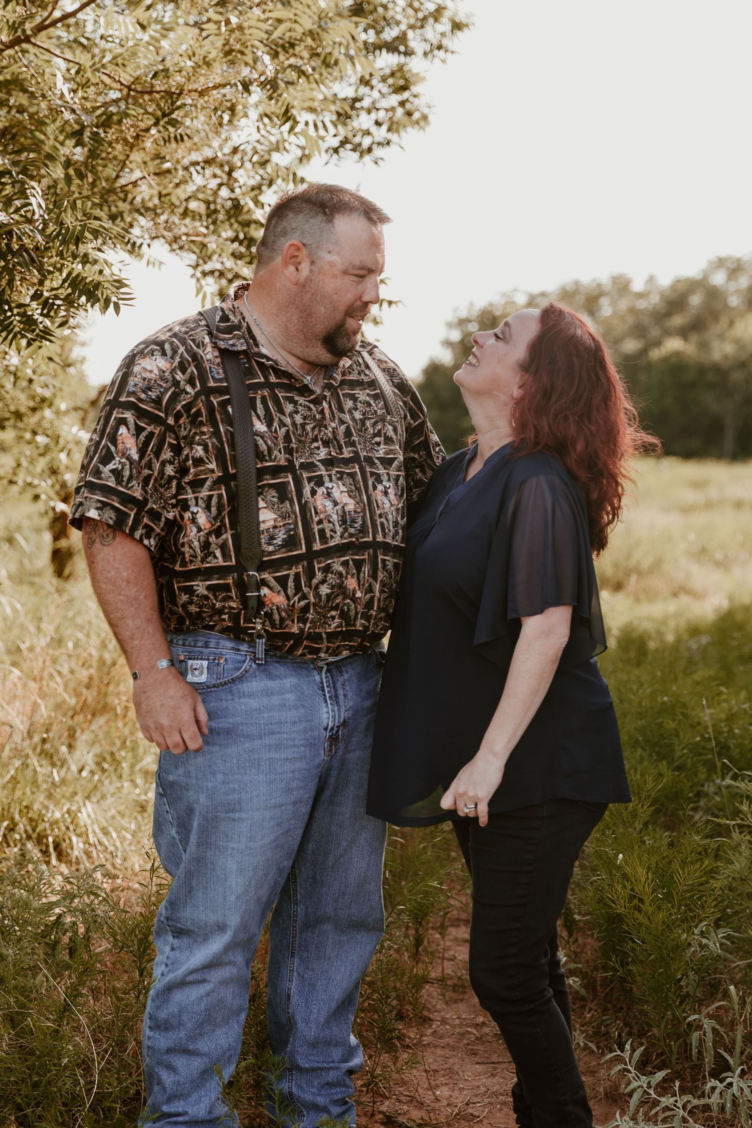 Four romantic photos of a couple in casual attire sharing tender moments outdoors in warm golden light.
