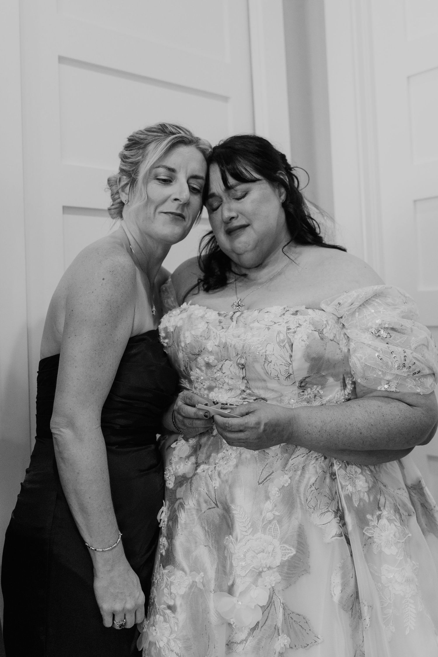 Black and white close-up series showing two women sharing intimate moments in wedding attire.