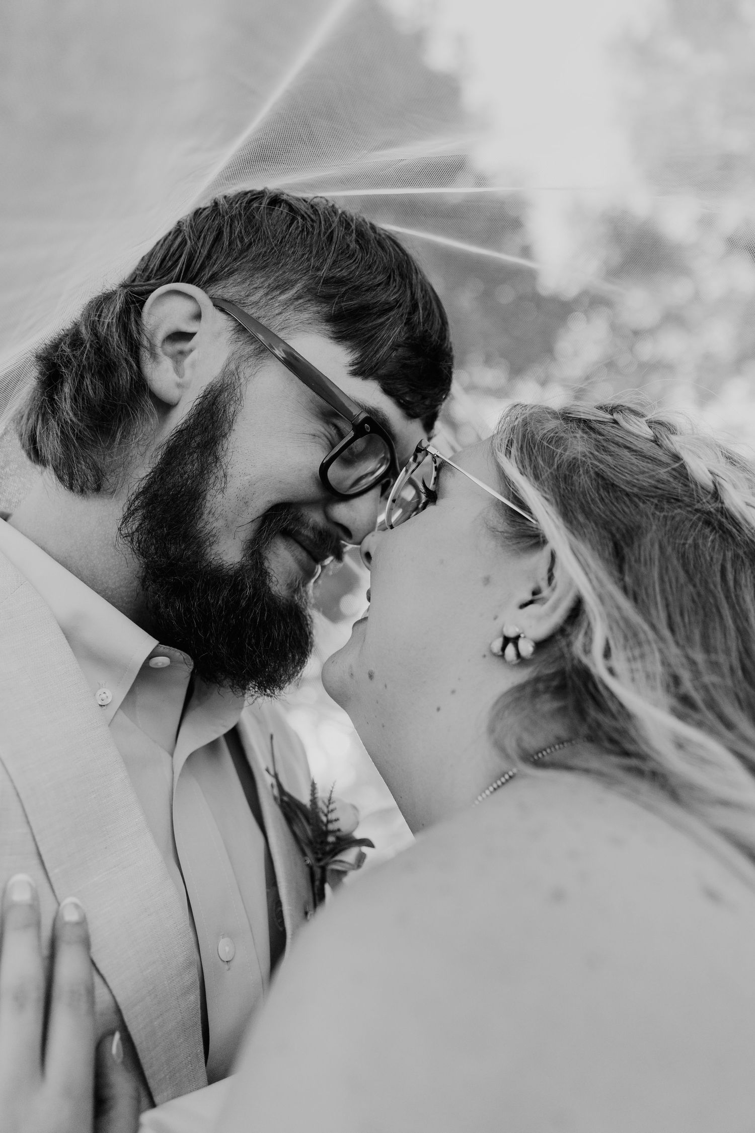 A romantic black and white photo series showing tender moments between newlyweds in close-up shots.