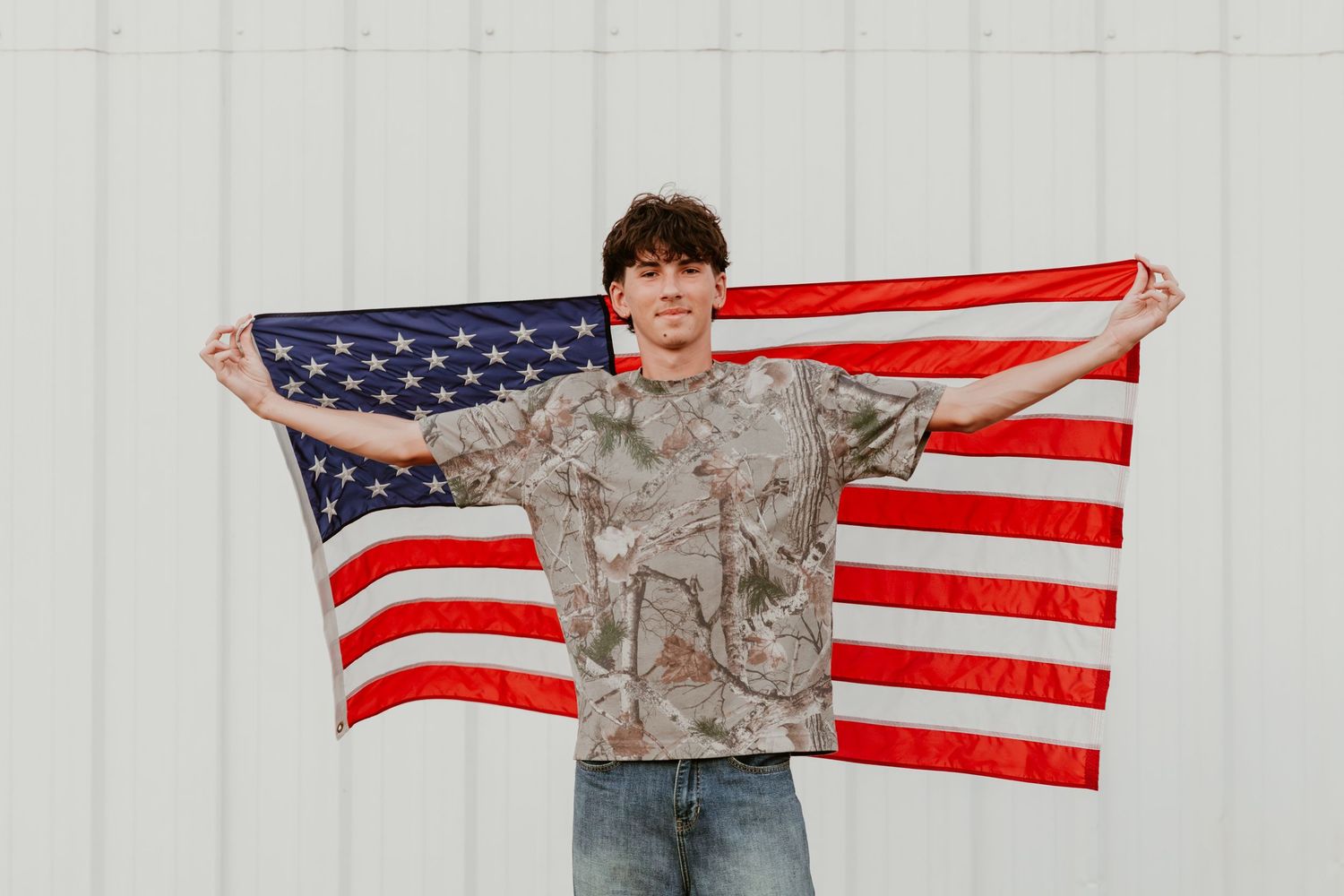 A person holds the American flag behind them while wearing military camouflage uniform in multiple posed shots.