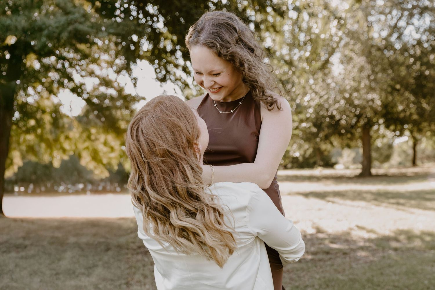 A romantic outdoor photoshoot sequence showing a couple dancing in golden sunlight among trees.