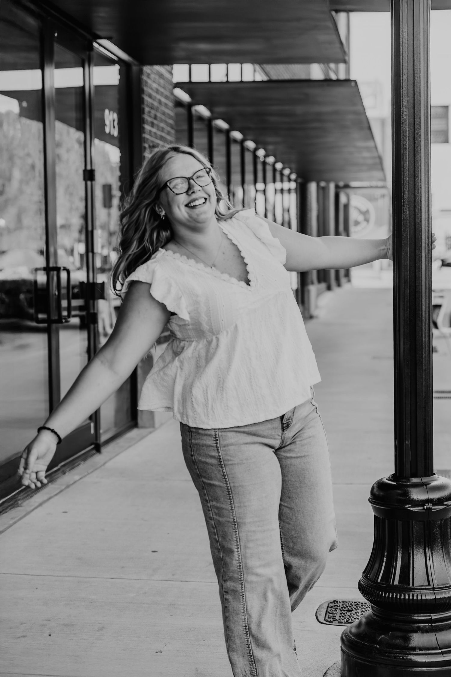 A series of vintage black and white photos showing a person in casual attire posing against store fronts and columns.