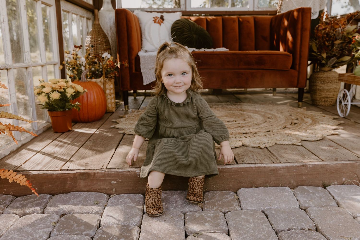 A series of candid autumn family photos taken on a rustic wooden porch with pumpkins and fall decor.