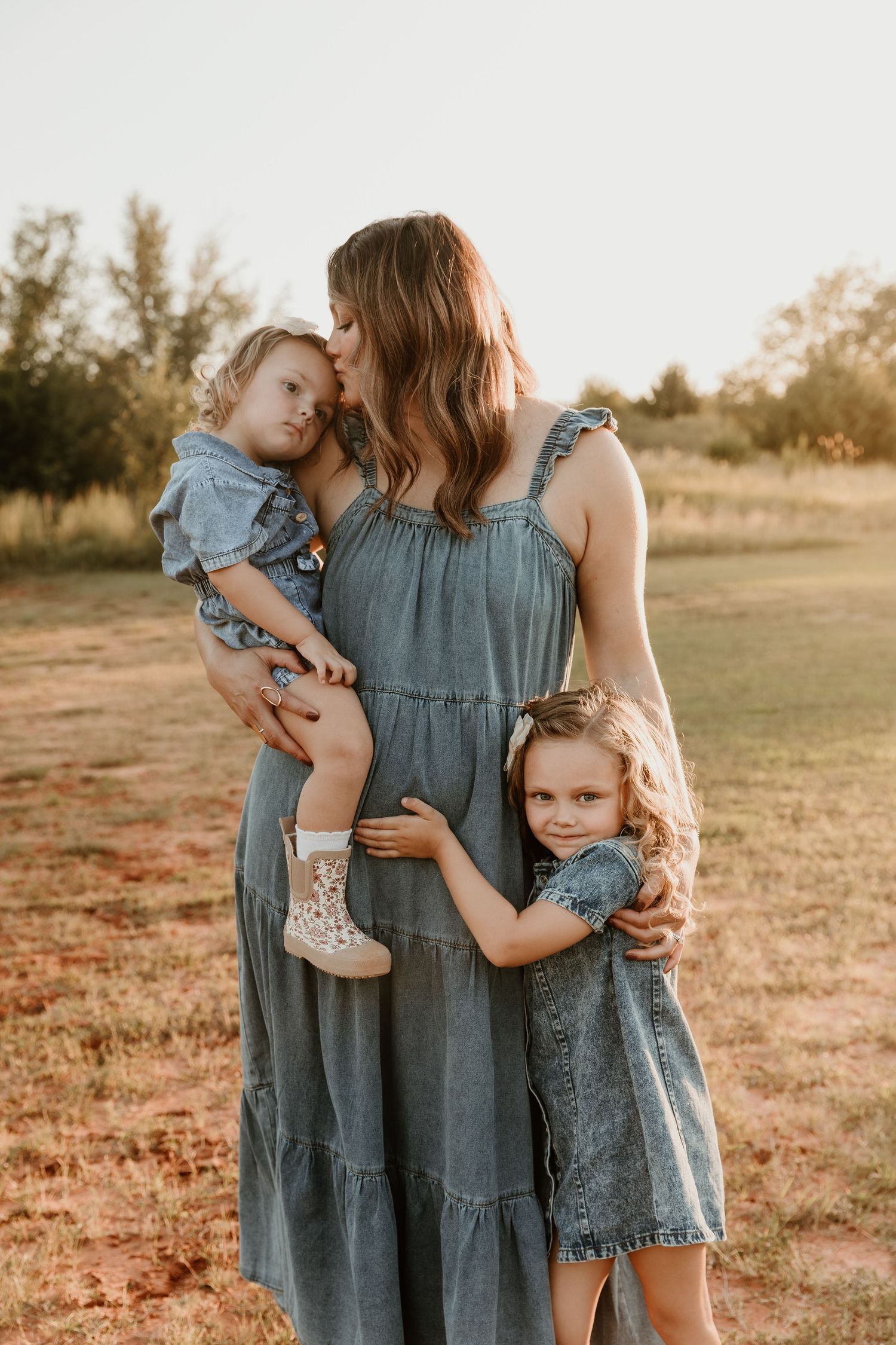 A series of outdoor family photos showing coordinated denim outfits during golden hour in a grassy field.
