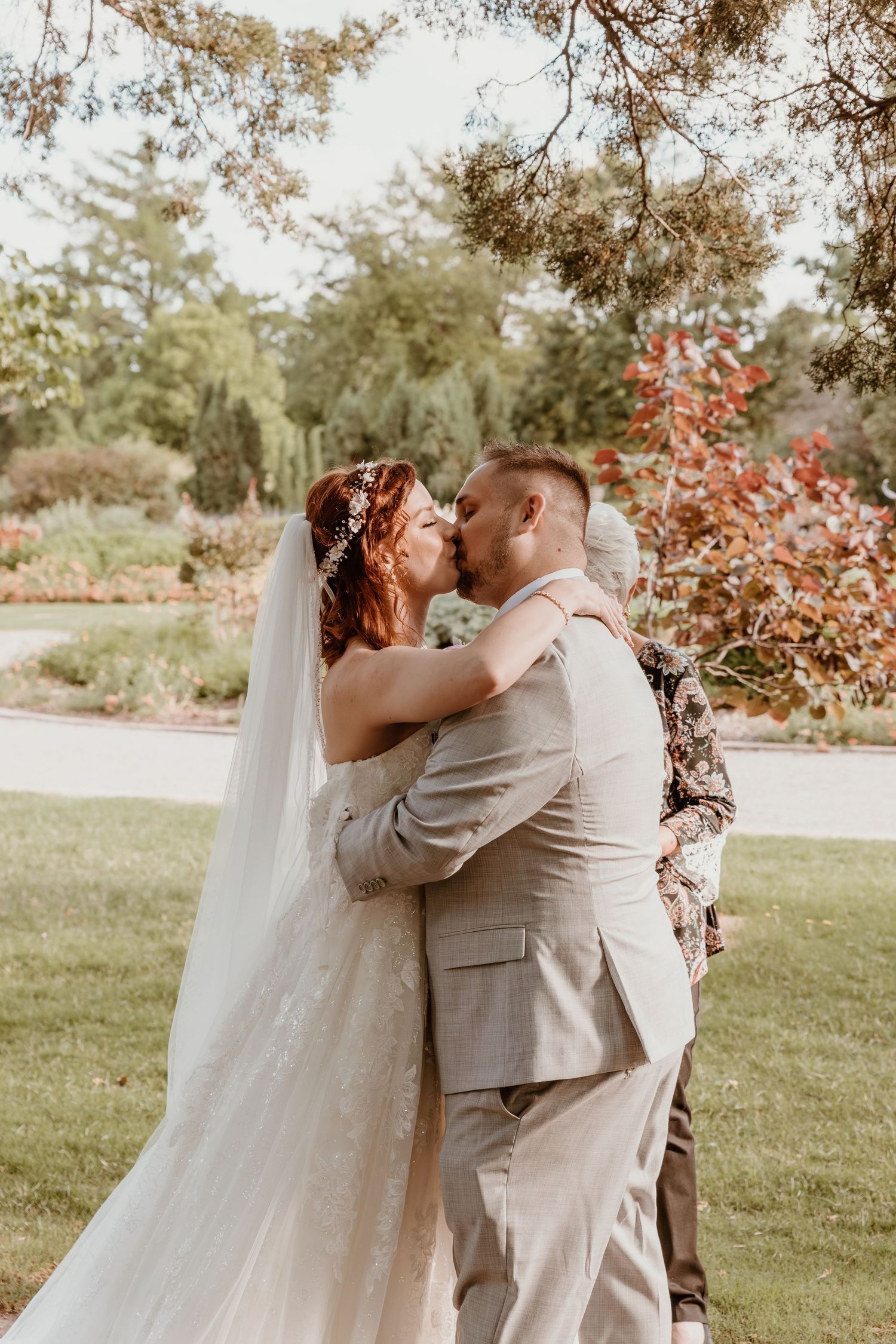 A sequence of wedding photos capturing a couple's first kiss and intimate moments against a natural outdoor backdrop.