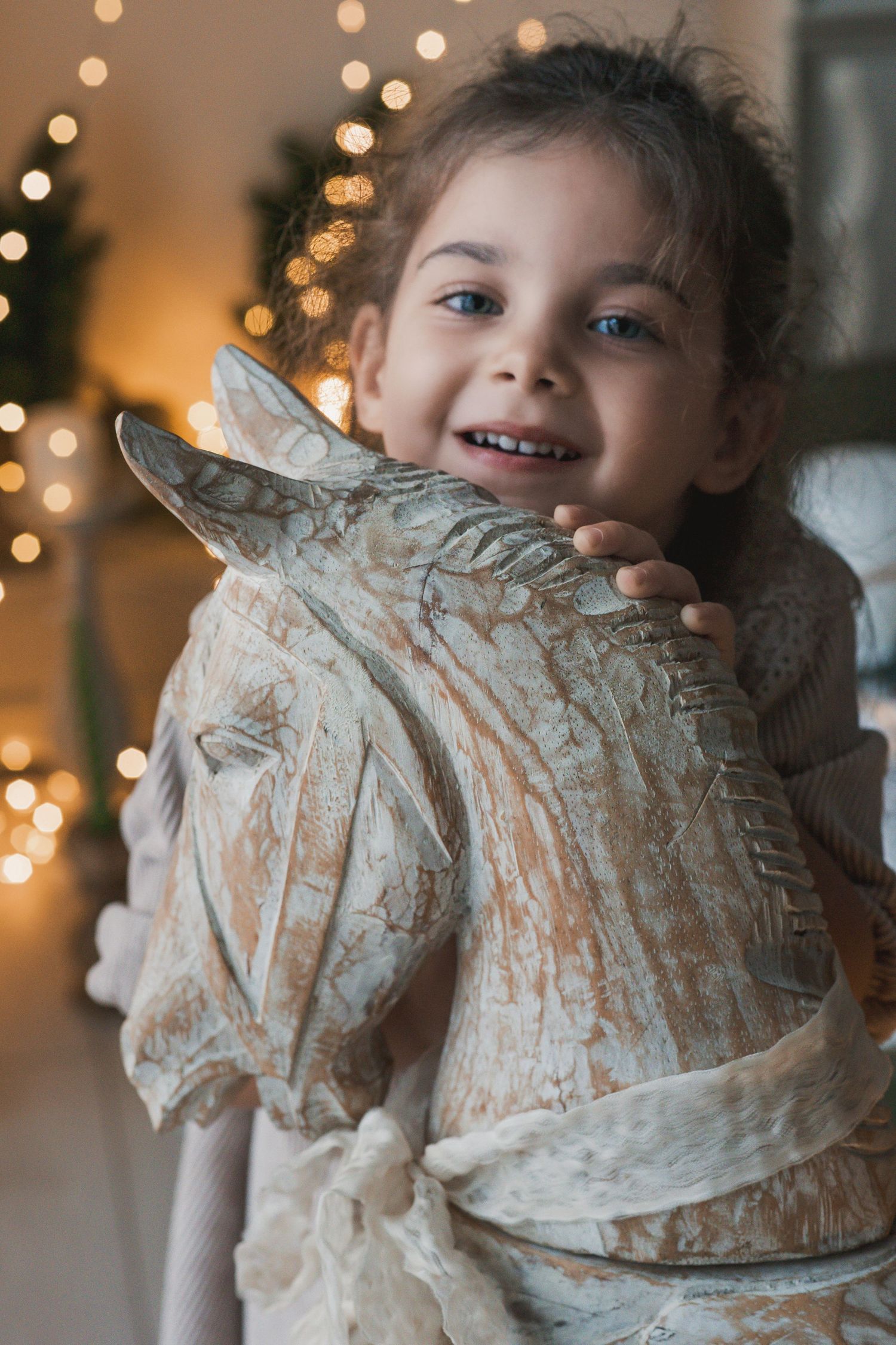 A child plays with flour while baking, creating a messy but joyful moment with bokeh lights in the background.