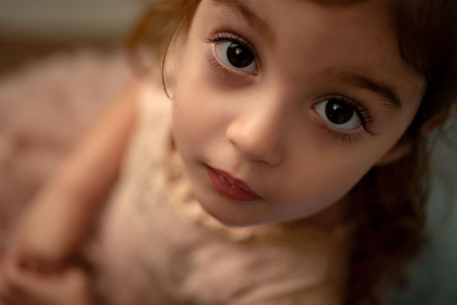 Close-up portraits showing various facial expressions and angles in warm lighting against a blurred background.