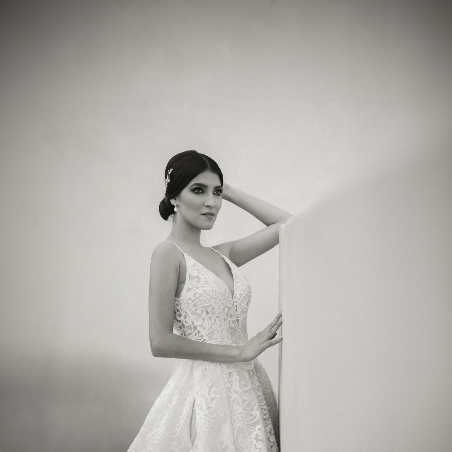 Elegant lace wedding dress with plunging neckline and full skirt captured in black and white.