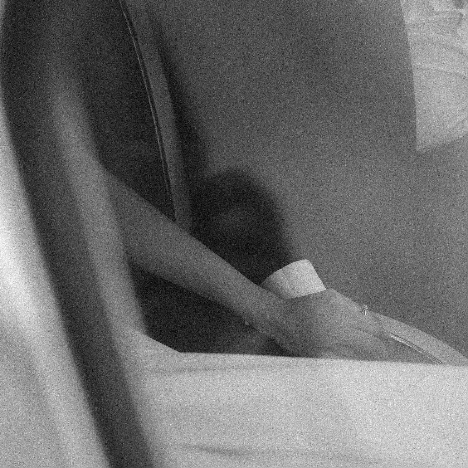 Ethereal black and white close-up of formal dress fabric and details.