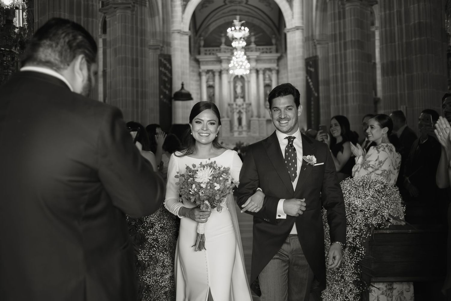 Wedding ceremony taking place inside a grand cathedral with gothic architecture.
