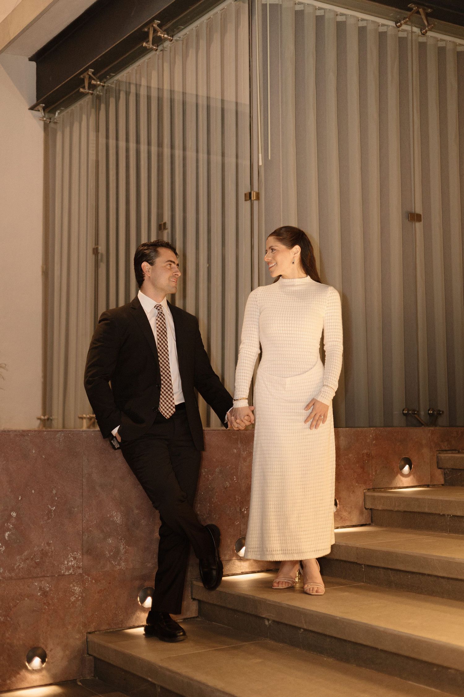 A sequence of photos showing a couple on steps in formal attire, with the man in a black suit and woman in white dress.