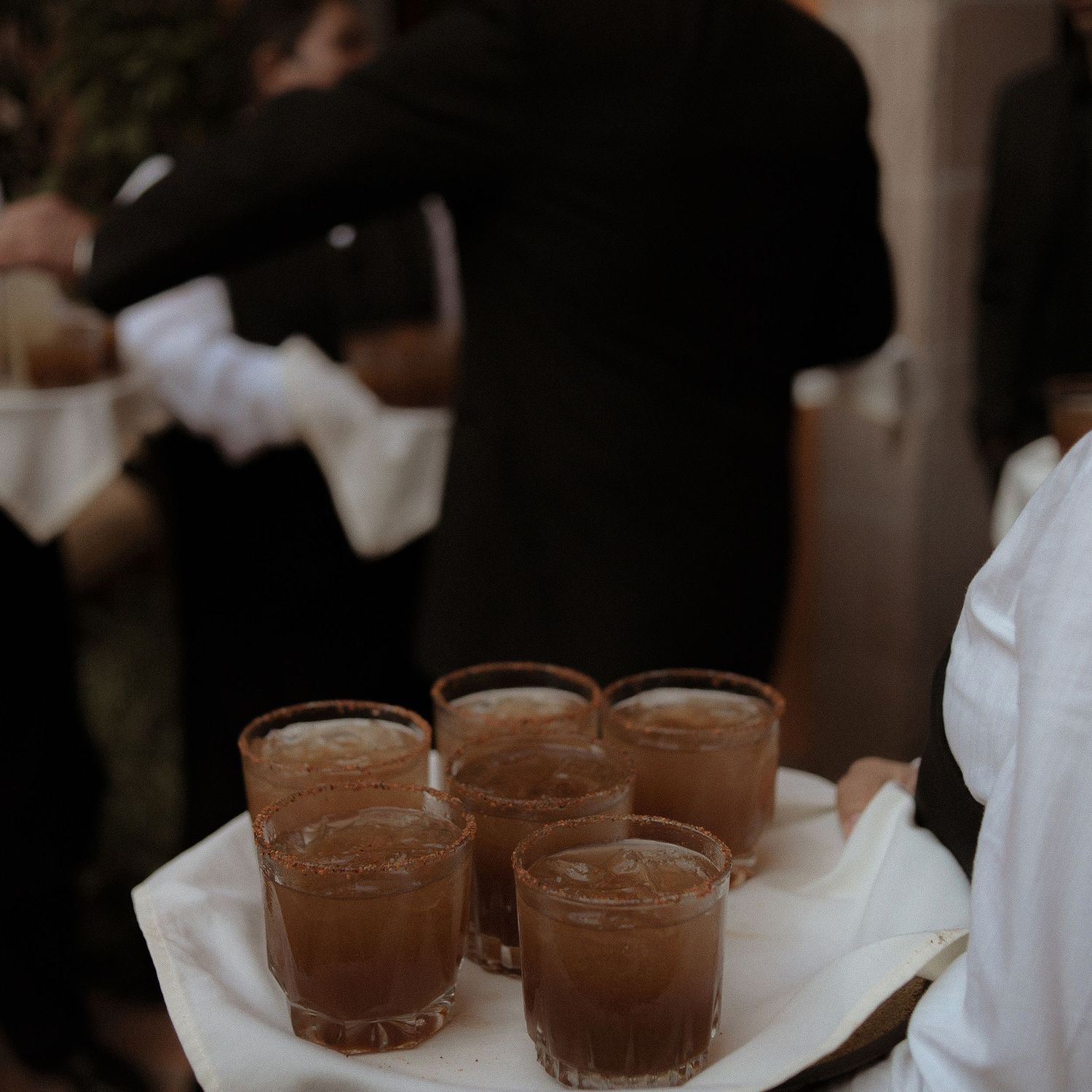 Dark toned photo of chocolate desserts served on white napkins.