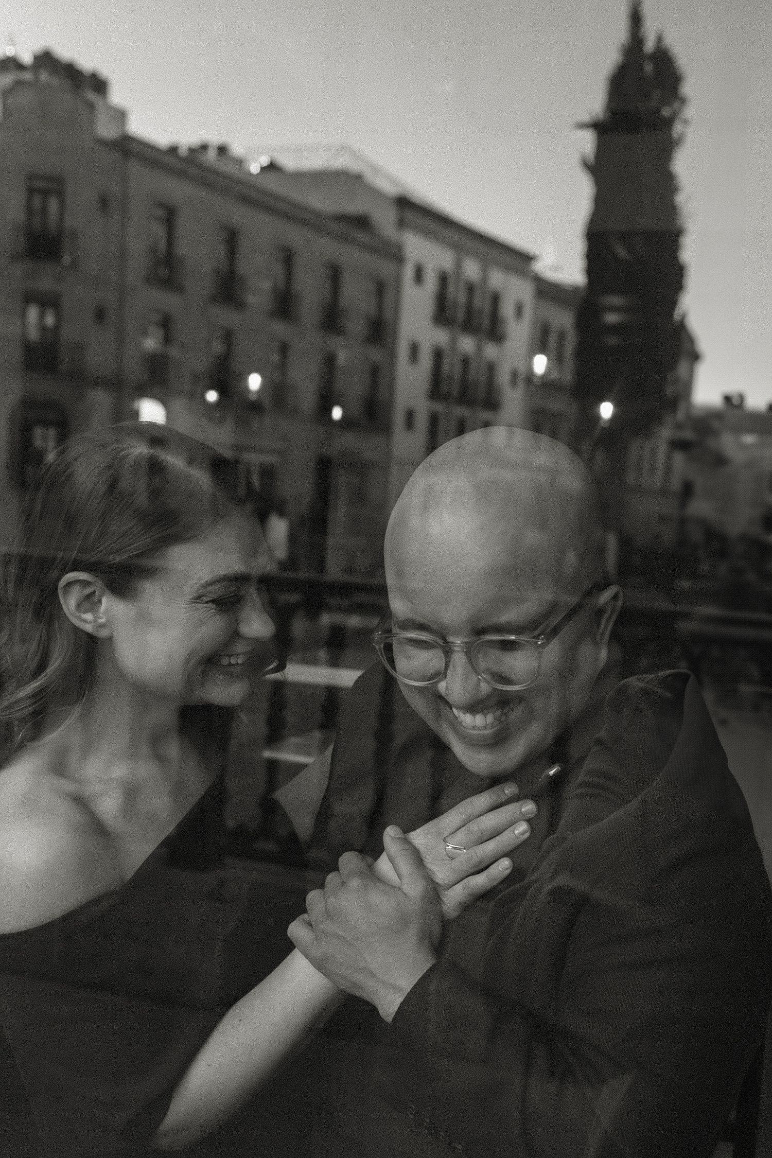 Black and white candid photographs through window glass showing joyful moments.
