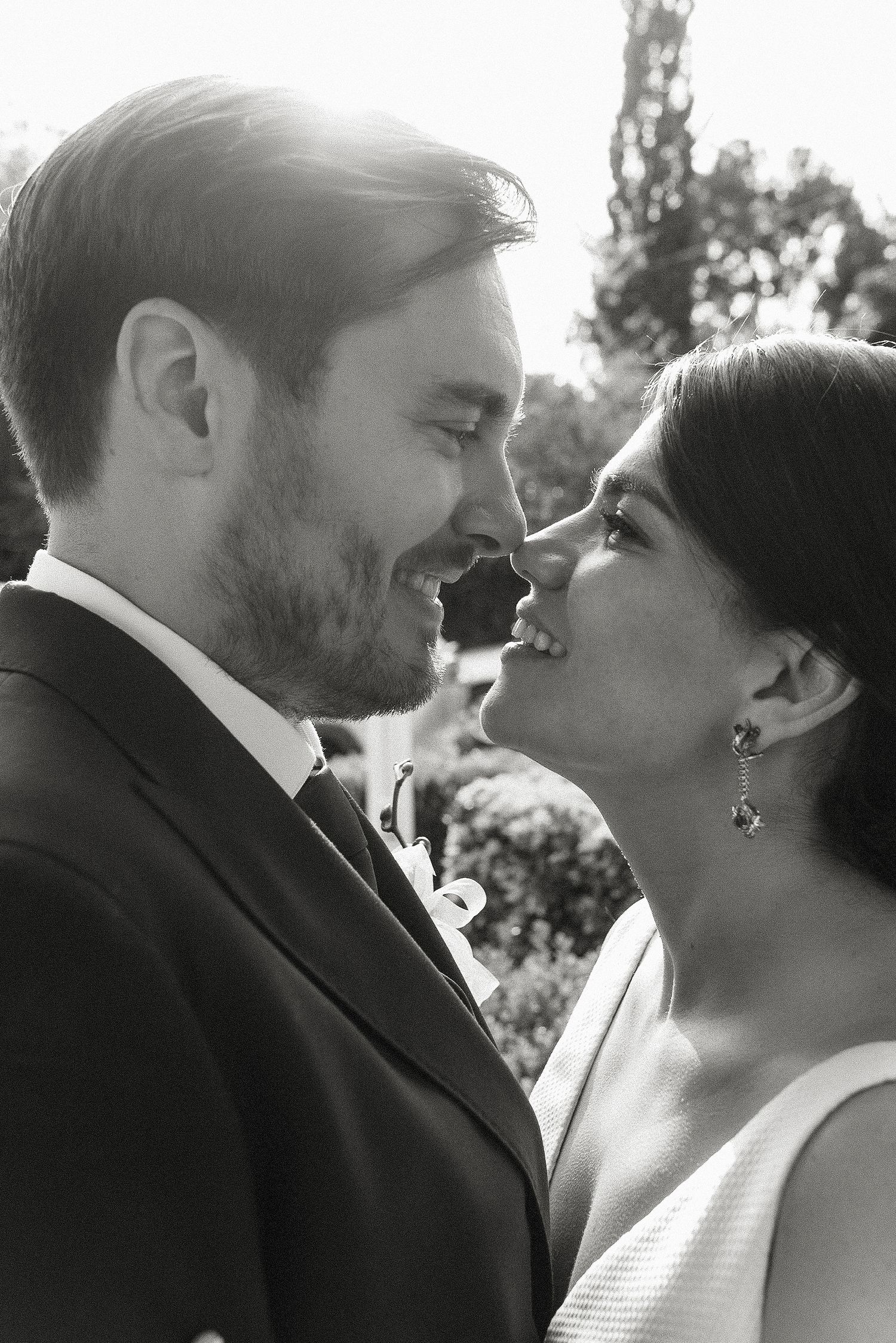 A series of romantic black and white close-up shots showing tender moments between newlyweds.