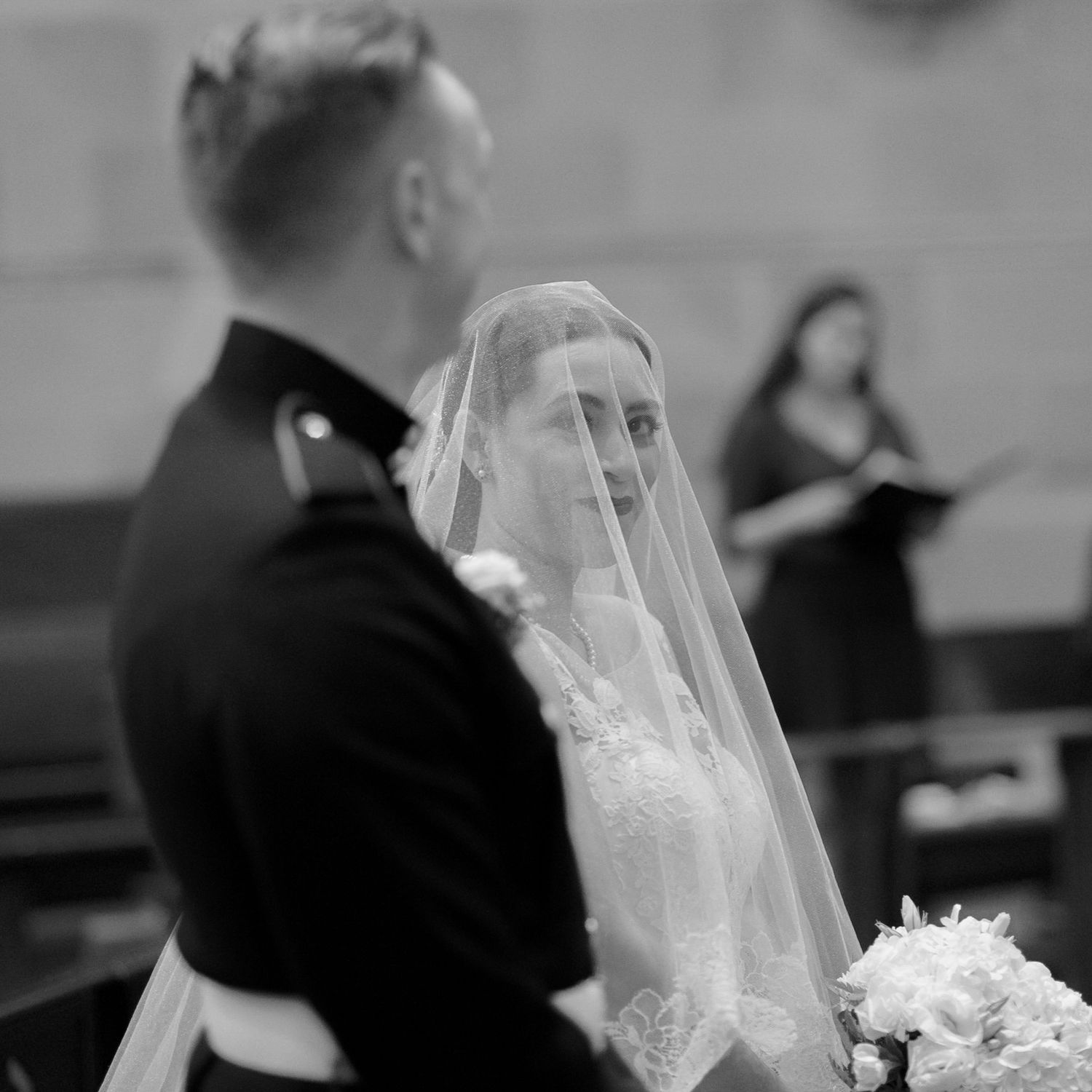 A classic black and white wedding ceremony moment captured in a traditional church setting.