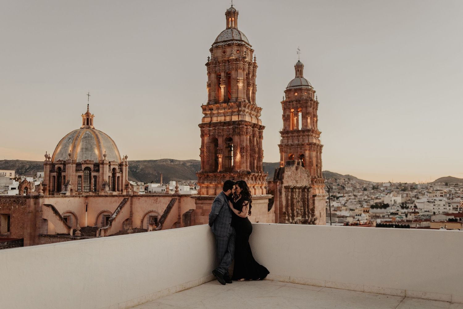 Ornate cathedral towers and domes against a clear sky showcase beautiful Mexican colonial architecture.