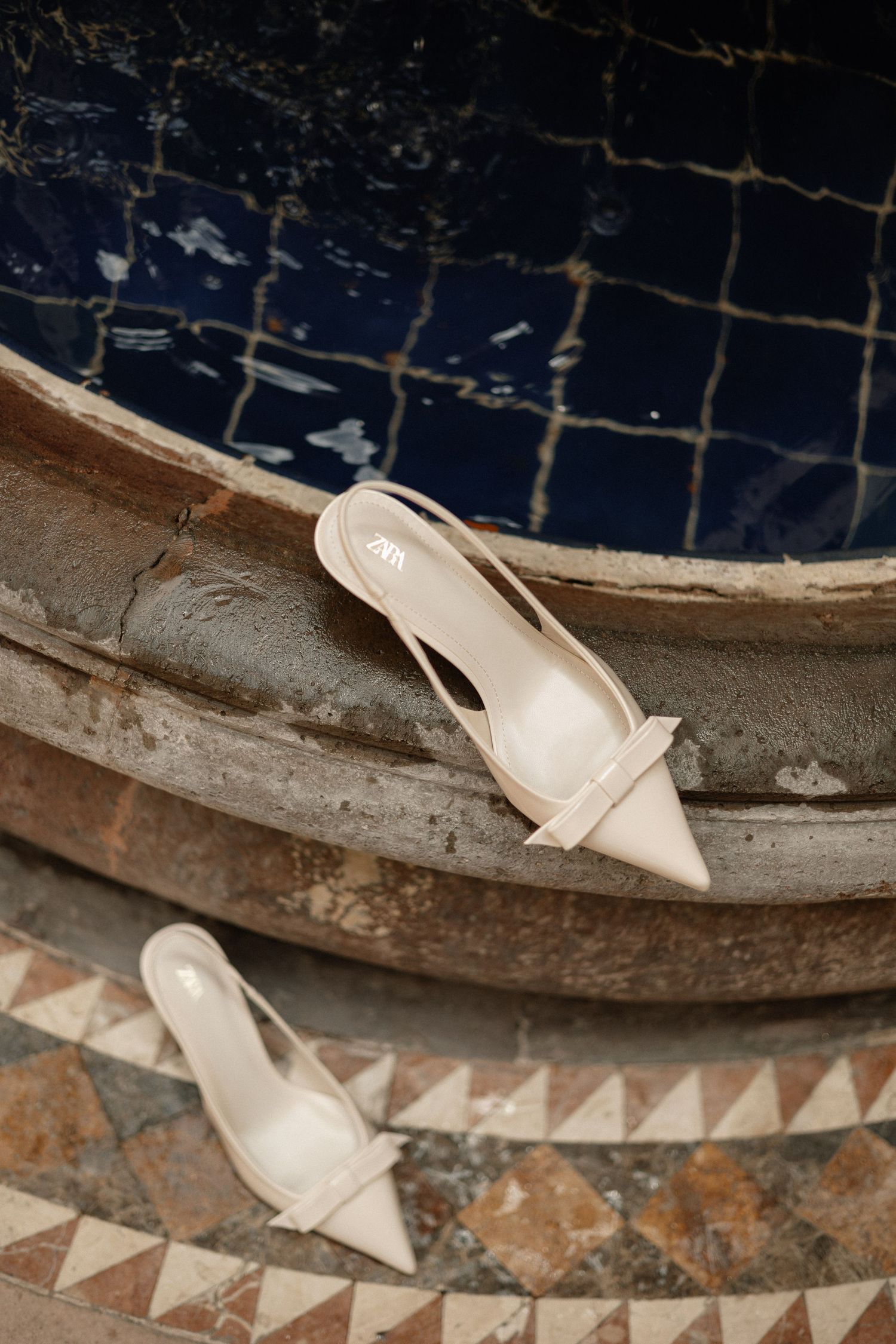 Close-up sequence showing a tire or wheel rim with white paint or markings being applied in a triangular pattern.