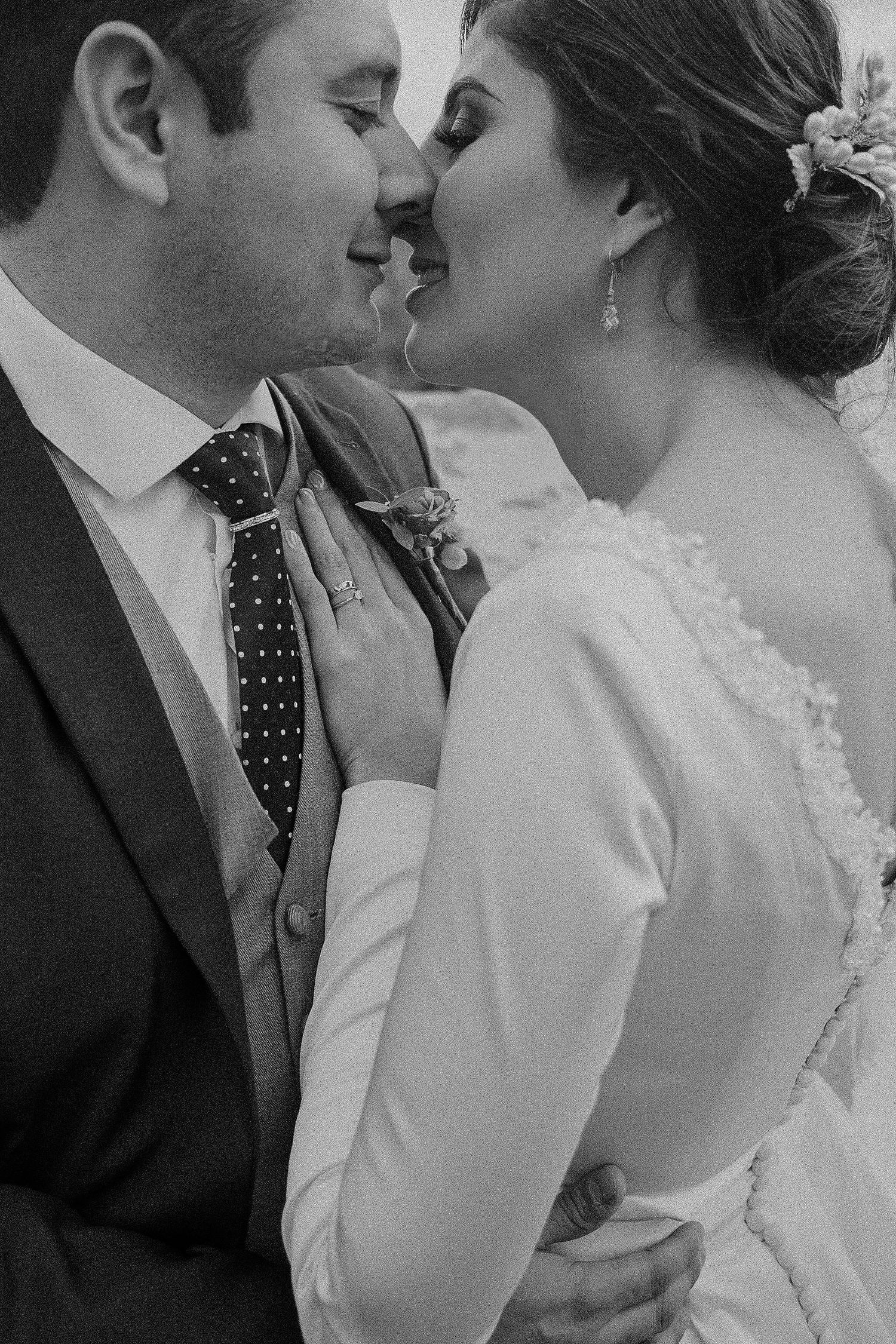 A series of romantic black and white close-up shots showing tender moments between newlyweds.