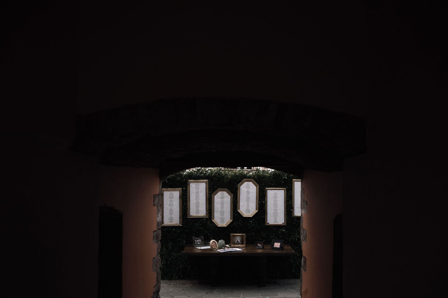 Dark and moody reception venue with dramatic lighting and architectural elements.