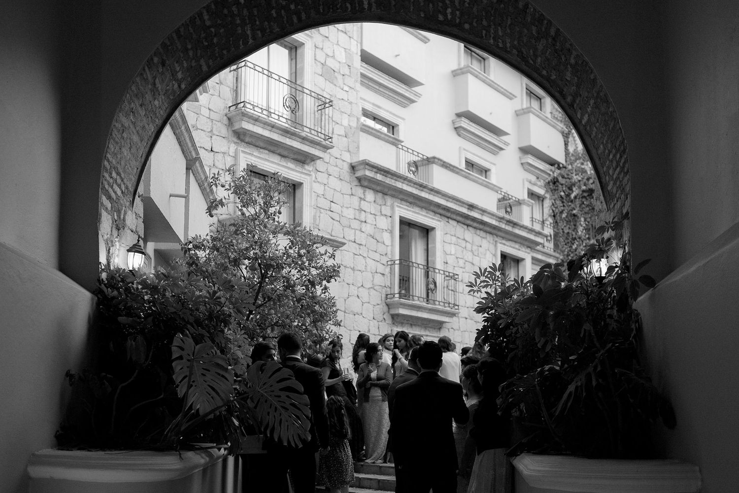 View through an arched doorway of a historic stone building exterior.