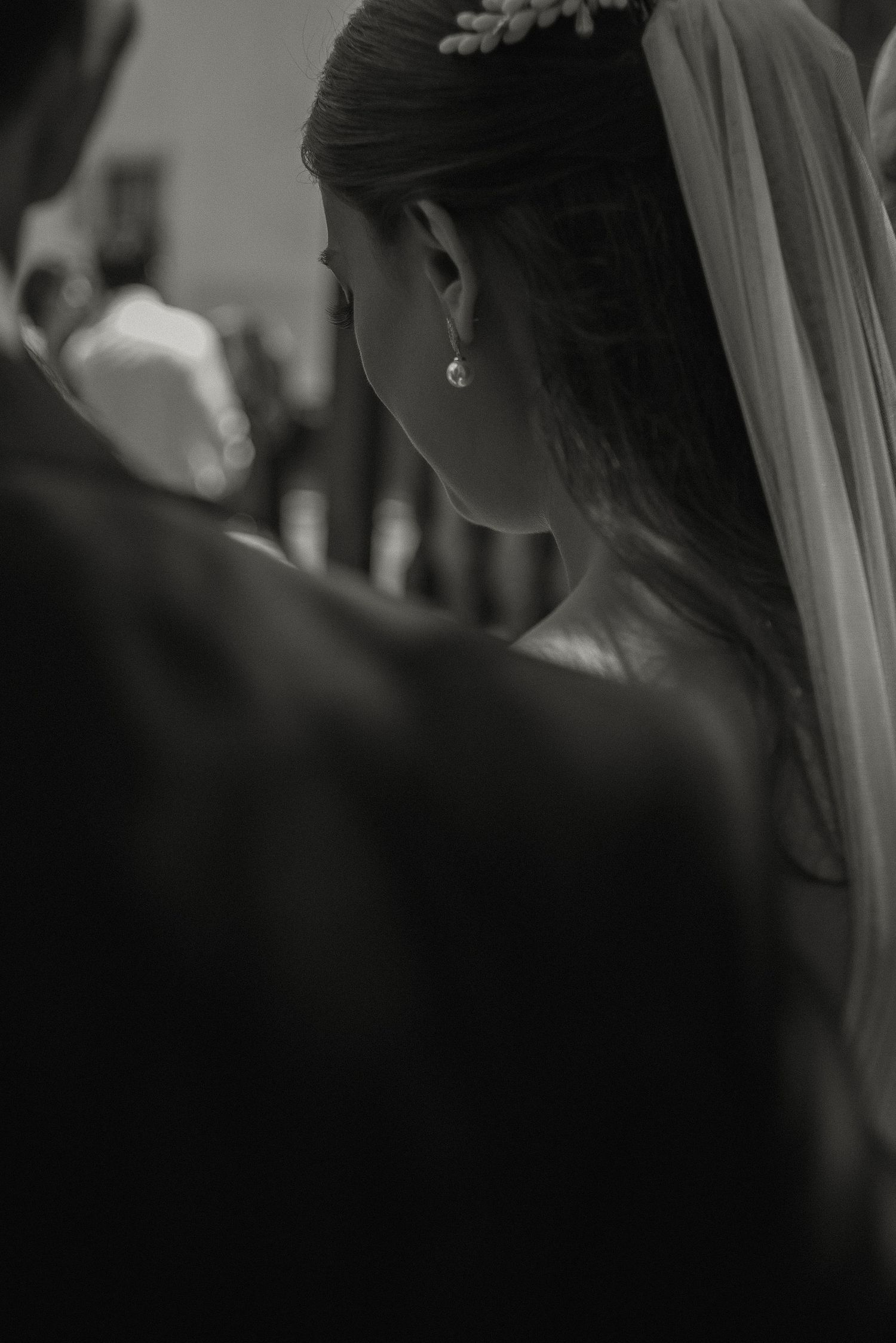 Close-up detail of bridal veil and hair accessories in black and white.