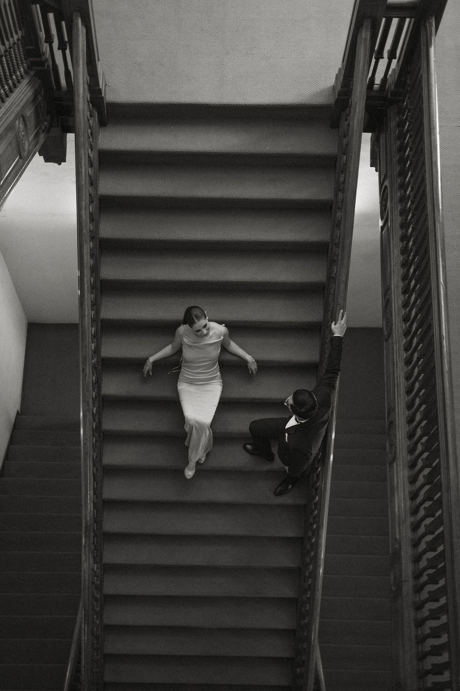 A sequence of black and white photos showing someone walking up dark stairs in an artistic composition.