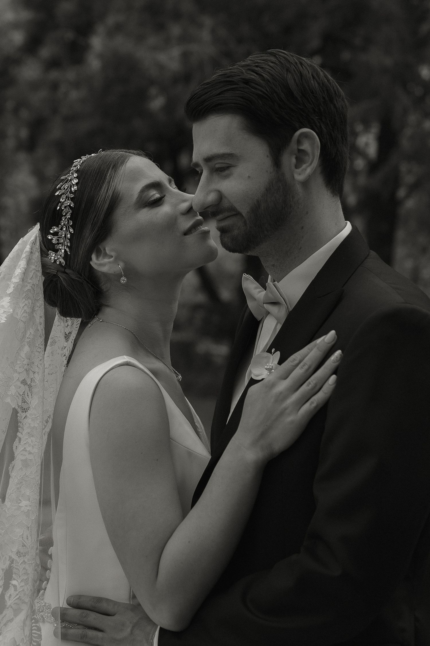 A romantic black and white wedding photo sequence showing tender moments between newlyweds sharing intimate kisses.